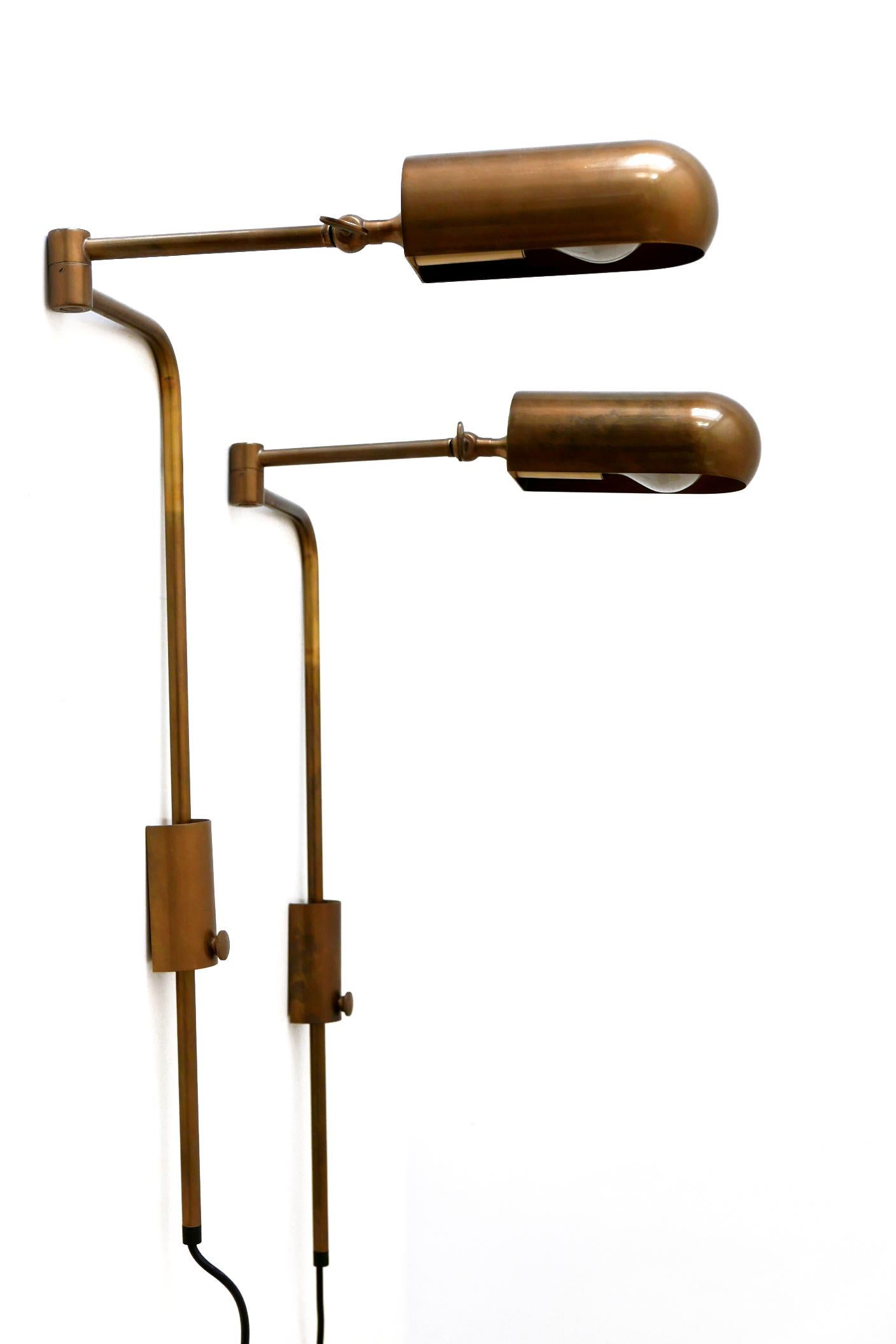 Set of two elegant and articulated brass wall lamps or reading lights. Designed and manufactured by Florian Schulz in 1980, Germany.

Adjustable height, arm and lamp shade in various ways. Interrupter on the cord.

Executed in brass, each lamp needs