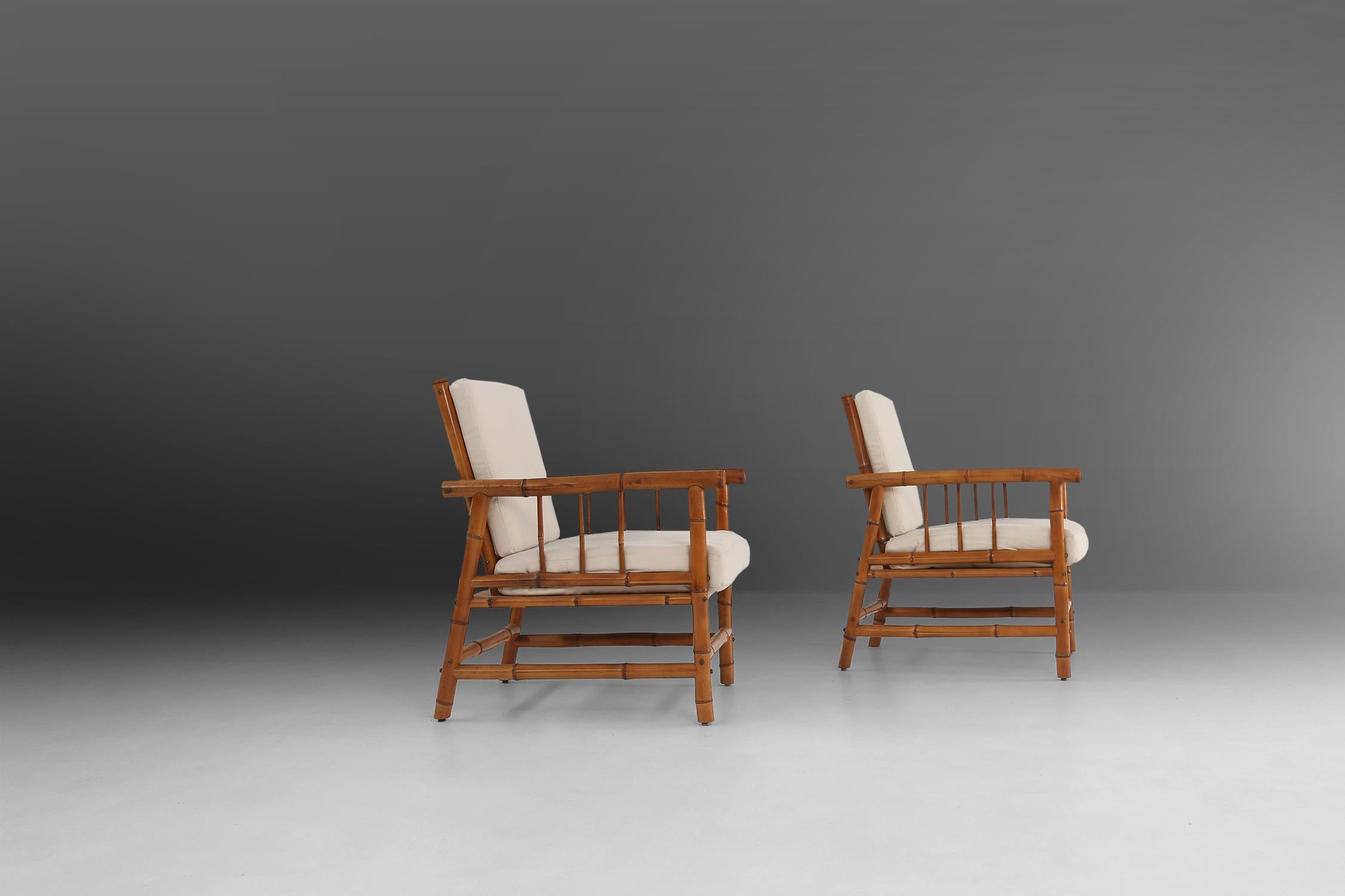 Set of two rattan, bamboo armchairs made in the 1960's.
cushions are completely reupholstered in beige fabric.
Has some great patina on the bamboo and beautiful bras screws.