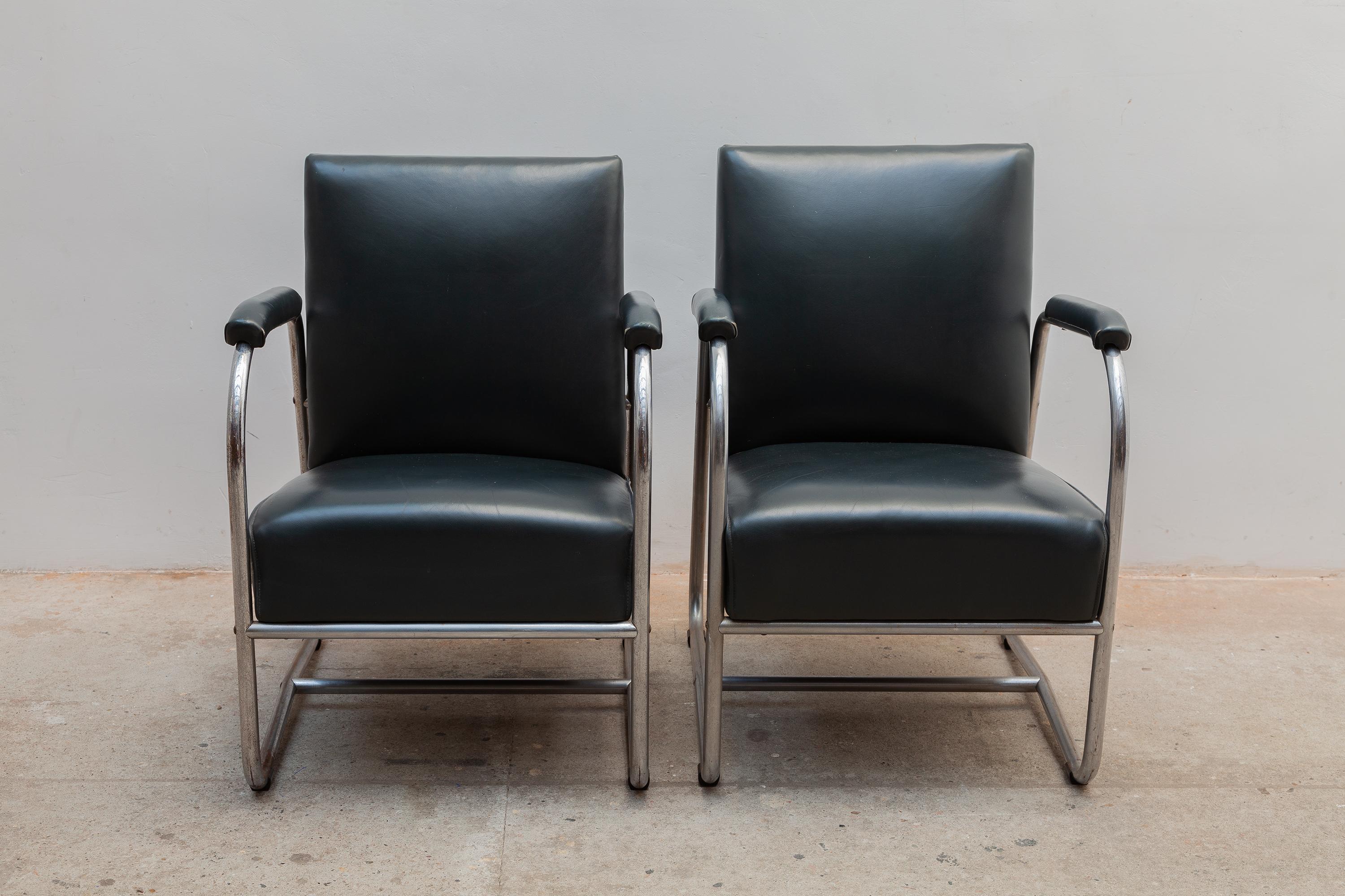 A pair of 1930s modernist lounge armchairs. Tubular chrome frames with original green faux leather upholstery -- no rips.
Dimensions: 53 W x 75 H x 54 D cm, seat 45cm high.
