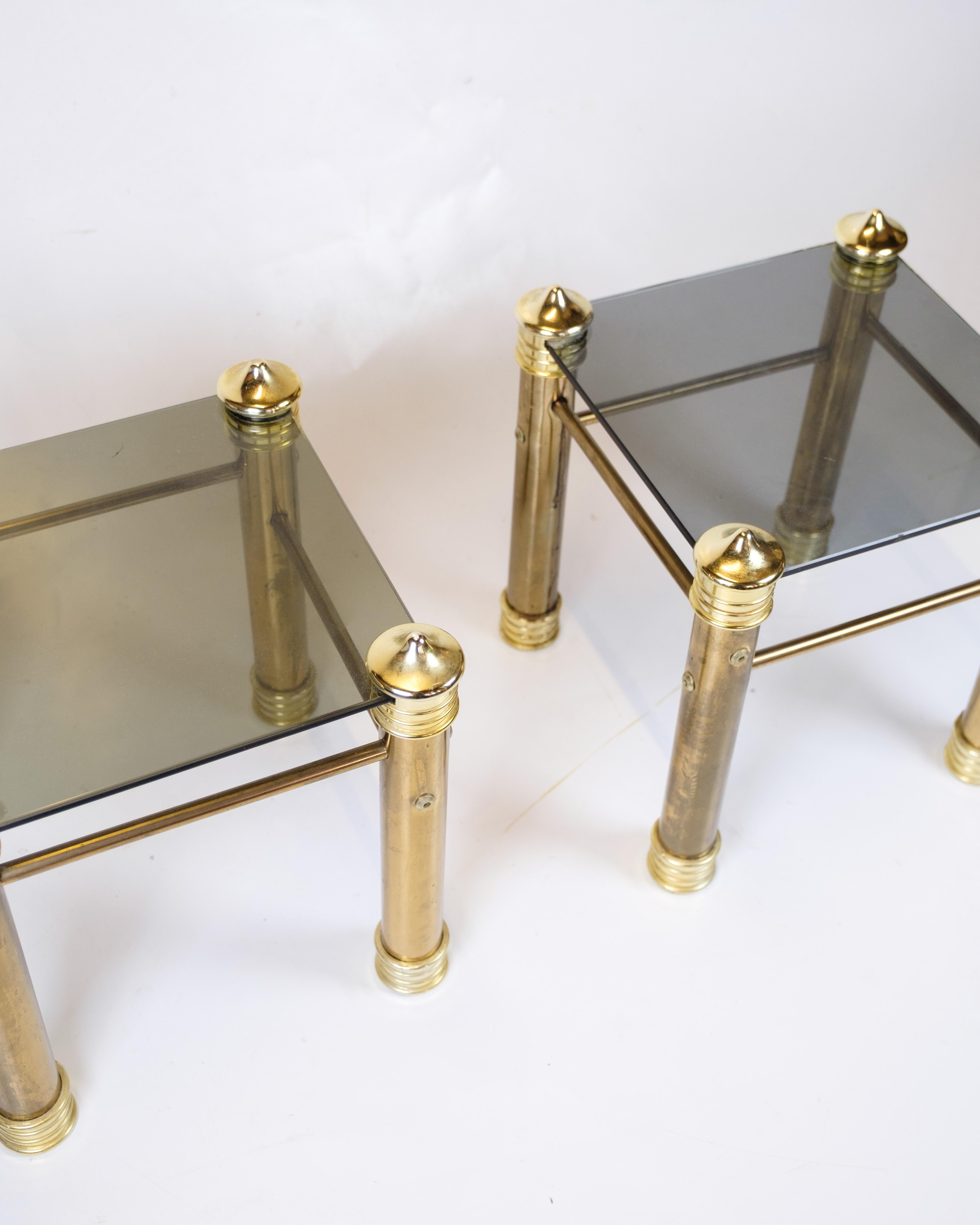 Set of 2 vintage bedside/side tables from the 1970s with brass legs and black glass top. Elegant retro design in great condition.

Period: 1970s
Materials: Brass, black glass
Quantity: 2 tables
Dimensions: H: 38 cm, W: 37 cm, D: 37 cm
