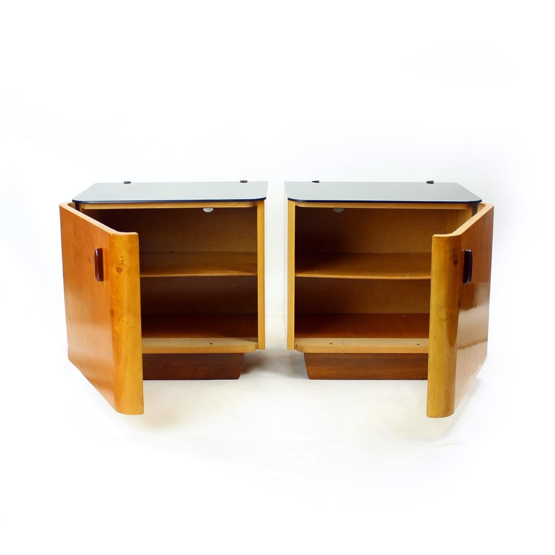 Set of two beautiful art deco bedside tables. Produced in Czechoslovakia in 1940s. The tables are square, made of beautiful walnut wood with amazing patters. The tables are in original, excellent condition. Each table has doors with rounded corner.
