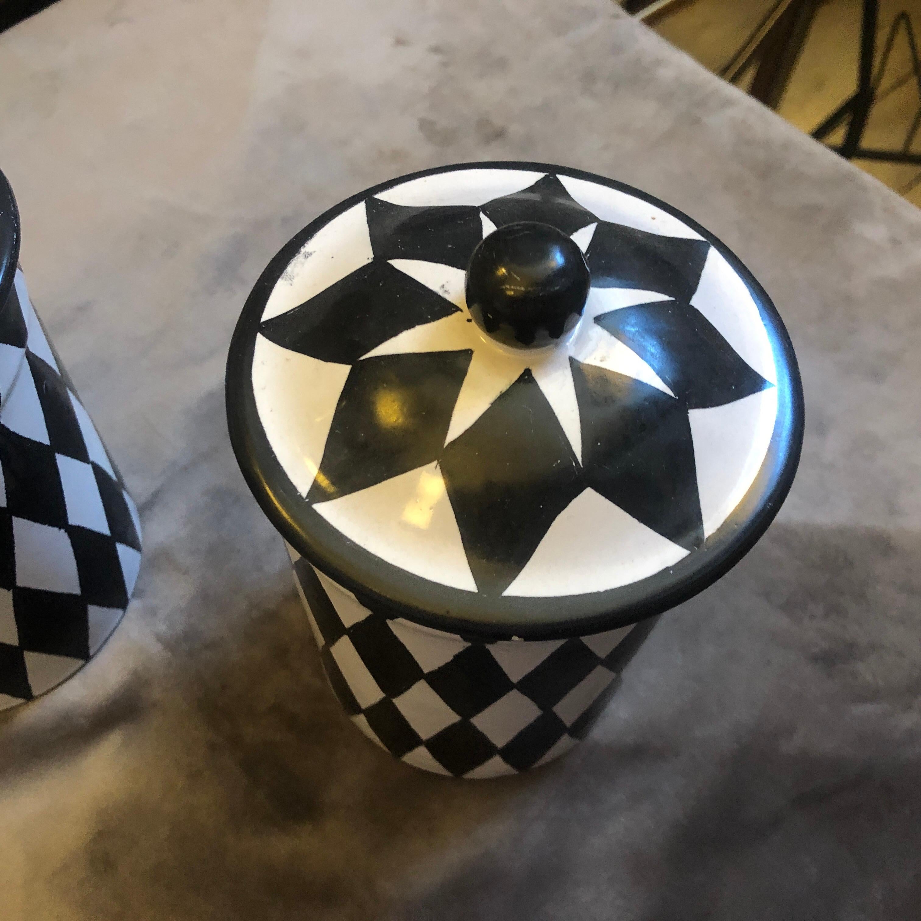 Two saltcellars made in Caltagirone, world famous small town in Sicily for handcrafted ceramics. The Mid-Century Modern black and white decoration is totally handmade especially for our shop. They are unique pieces.