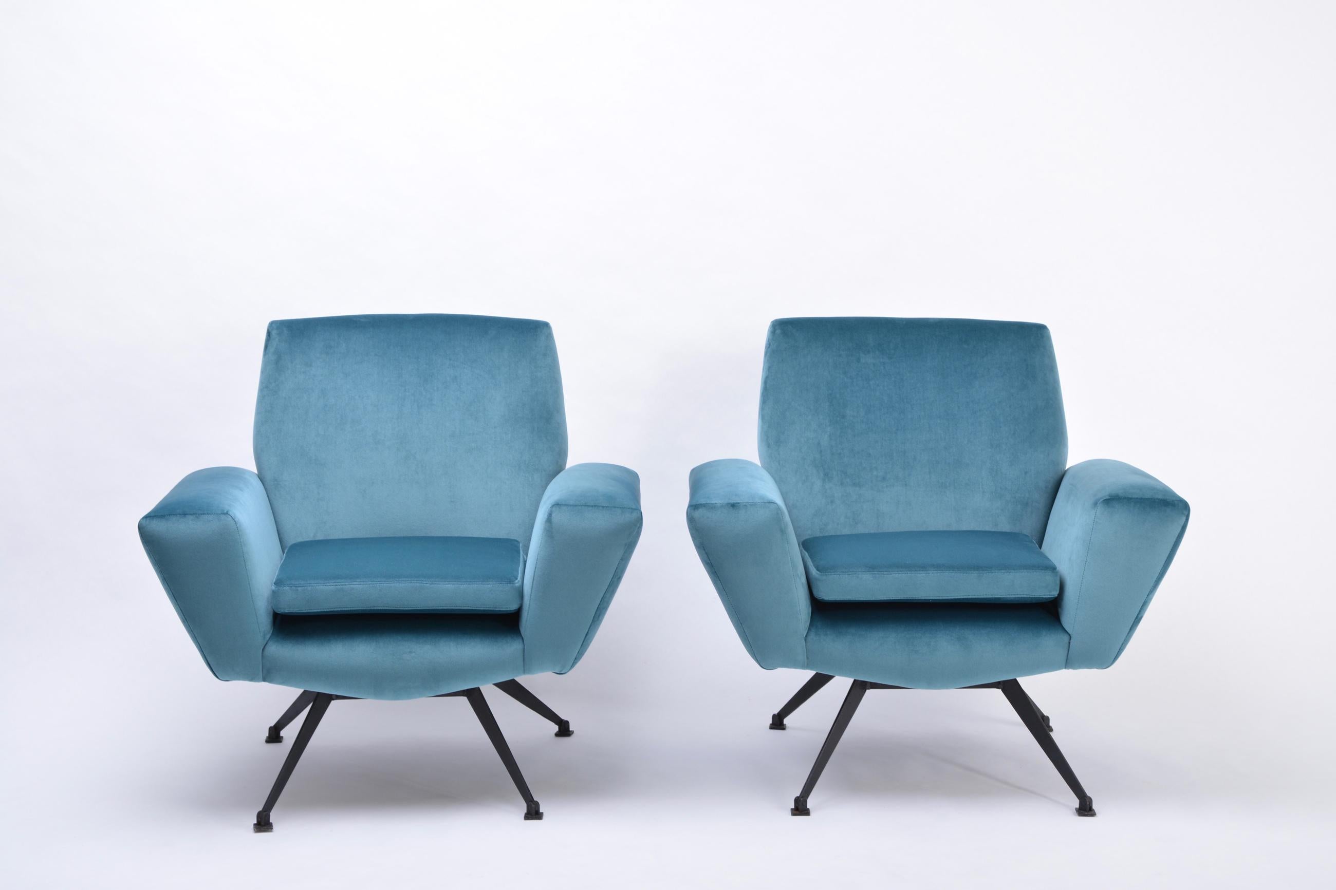 Pair of model 530 lounge chairs by Lenzi produced in Italy in the 1950s. The base and the four legs are made of a black metal. The chairs have been reupholstered in a beautiful blue colored velvet fabric. Cushions are loose.