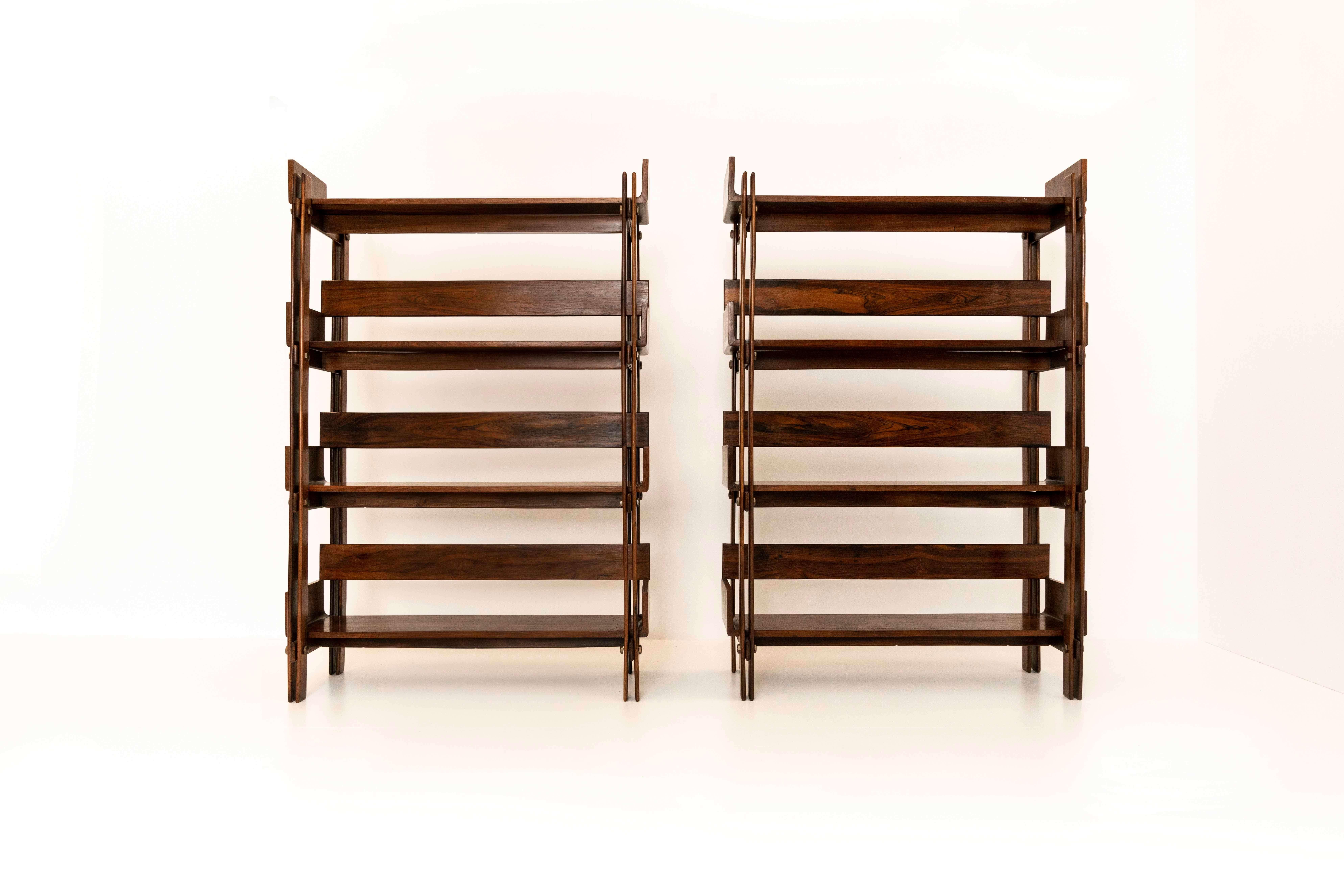 An impressive set of two bookcases by Sergio Rodrigues for Oca Brasil, 1960s. This set is made of Peroba wood, plywood, and brass. The bookcases have a very nice structure of wooden slats that are held together with brass knobs, where the structure