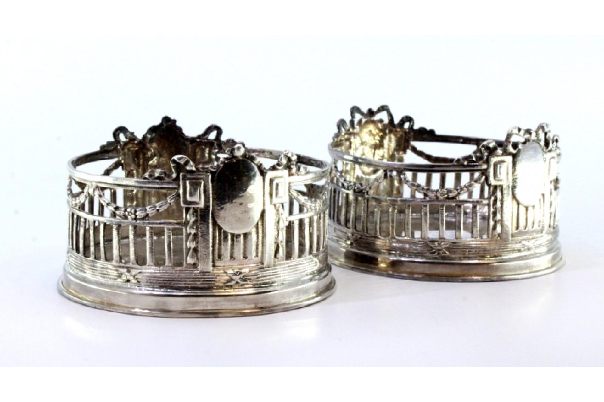 Description: Set of two silver bottle bottoms with monogram cards and surrounding strips. Metal: Silver. Origin: Turkish. Brand: Unknown. Weight: 337.41 grams. Dimensions: 9.5cmx6cm. Content: 925/1000. Assay Mark: Yes. Additional information: Good