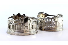 Ensemble de deux fonds de bouteille en argent découpé avec cartes de monogramme et bandes d'entourage