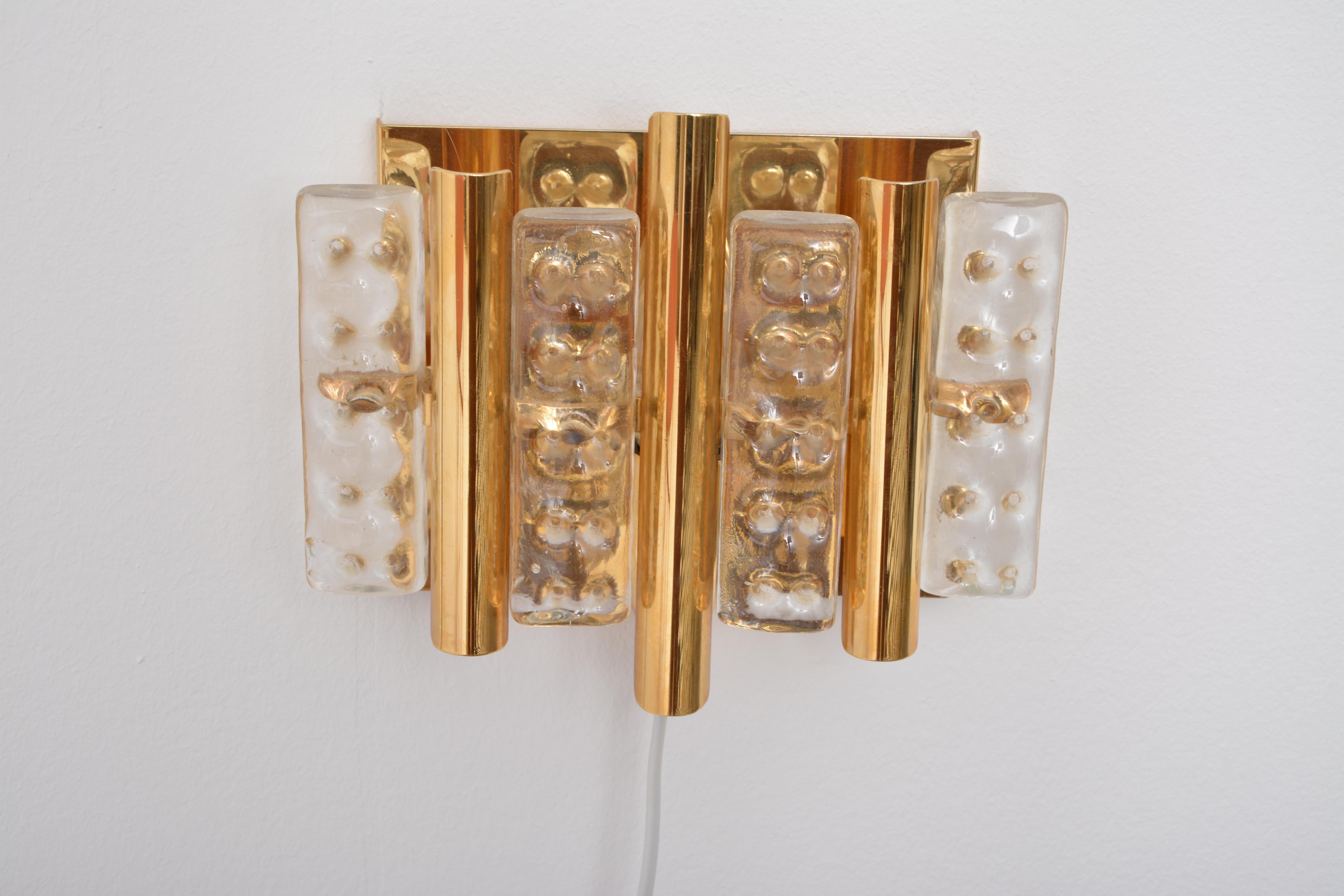 Set of two Brass and Glass Mid-Century Modern wall lamps by Carl Fagerlund for Lyfa and Orrefors

This set of two wall lamps was designed by Carl Fagerlund and produced in the 1960s by Lyfa.
The lamps are made of brass and glass.