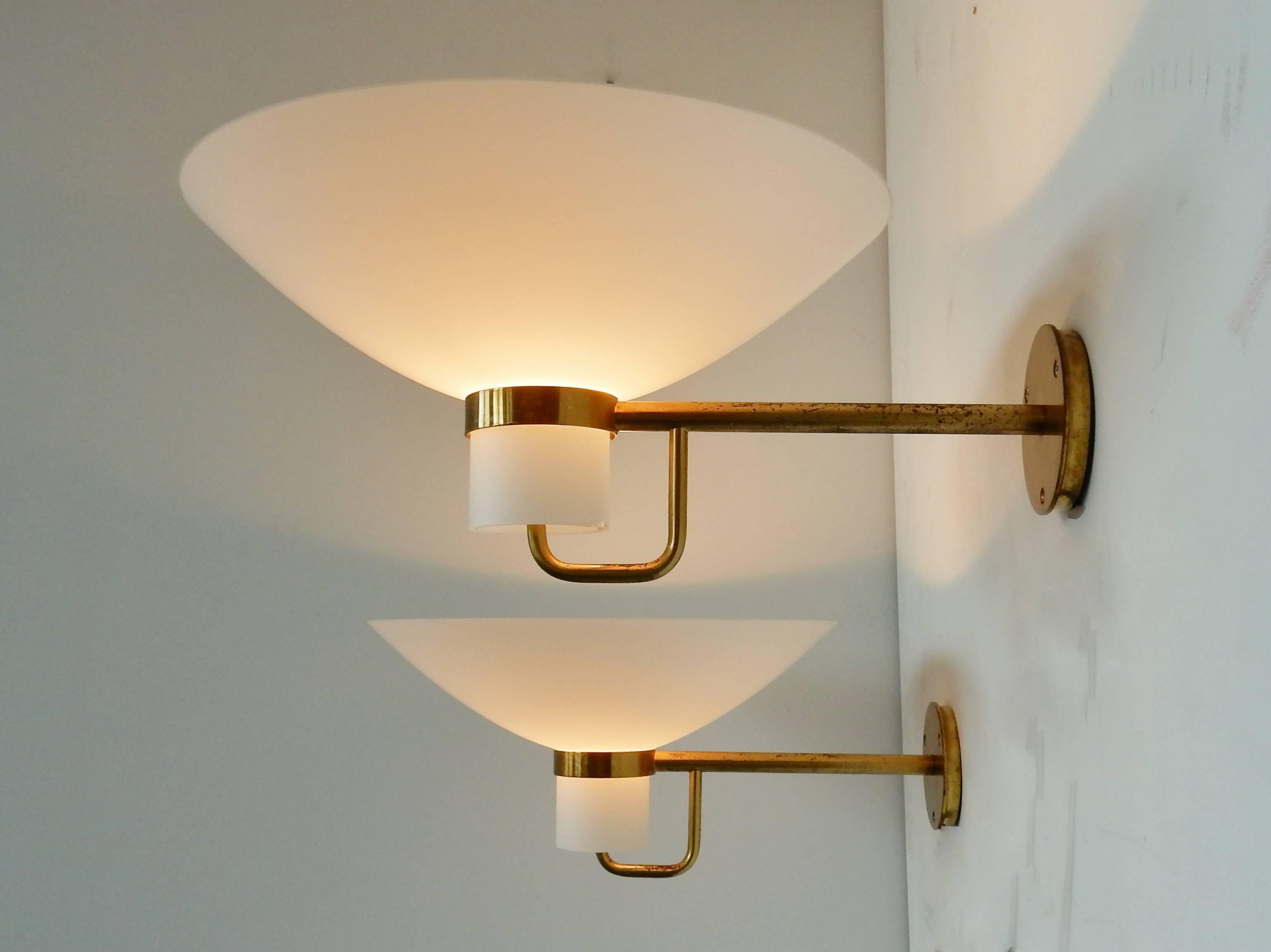This set of two wall lights are an amazing set of two. With some smaller chips to one glass and a close to perfect other glass, this set is a rare find. The design is very likely to be Scandinavian and presumably Swedish. We have this model