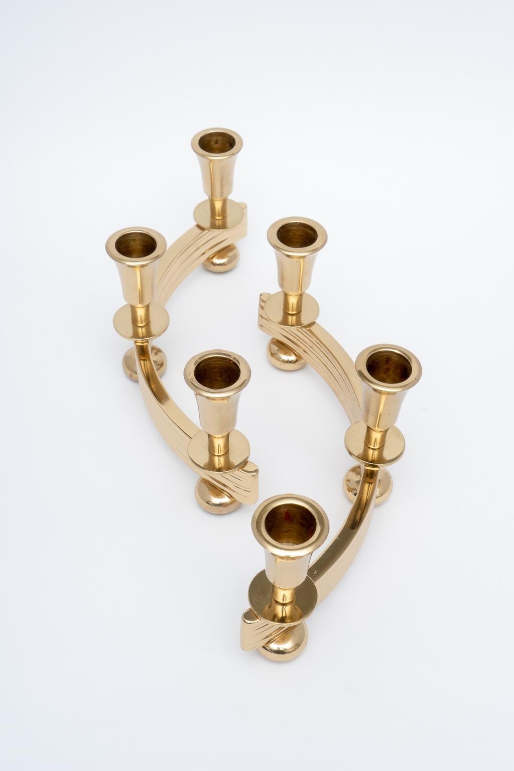 This stylish set of brass Art Deco style candle holders date to the 1930s-1940s and were fabricated by the Dirilyte company. They have been professionally polished and lacquered, and thus no tarnishing.