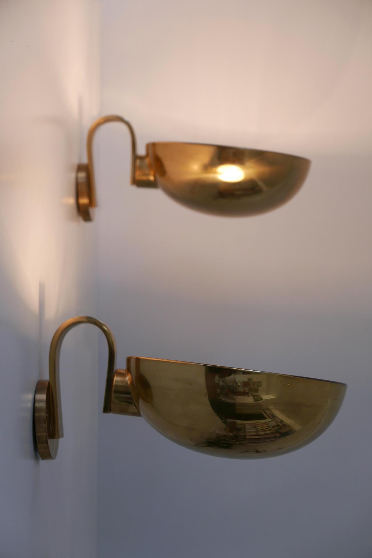 Set of two elegant Mid-Century Modern wall lamps or sconces. Designed and manufactured probably by Florian Schulz, 1970s, Germany. The lamp shades can be rotated.

Executed in brass sheet, each lamp comes with 1 x E27 Edison screw fit bulb holder,