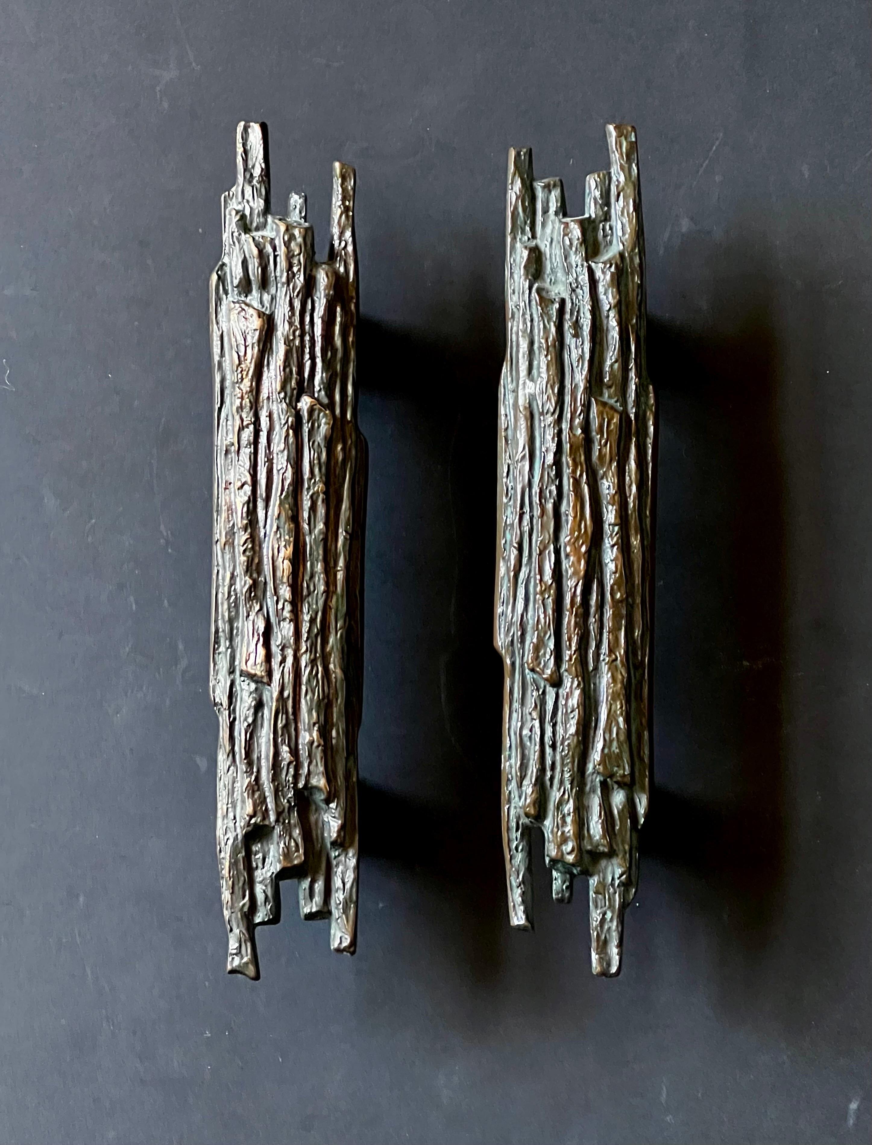 A set of two narrow bronze pull-or-push door handles, with raised pattern of tree bark. Mid-to-late 20th century, European.

The two pieces are of the same design, made of cast bronze. The metal has very nice changing tones from use, from very deep