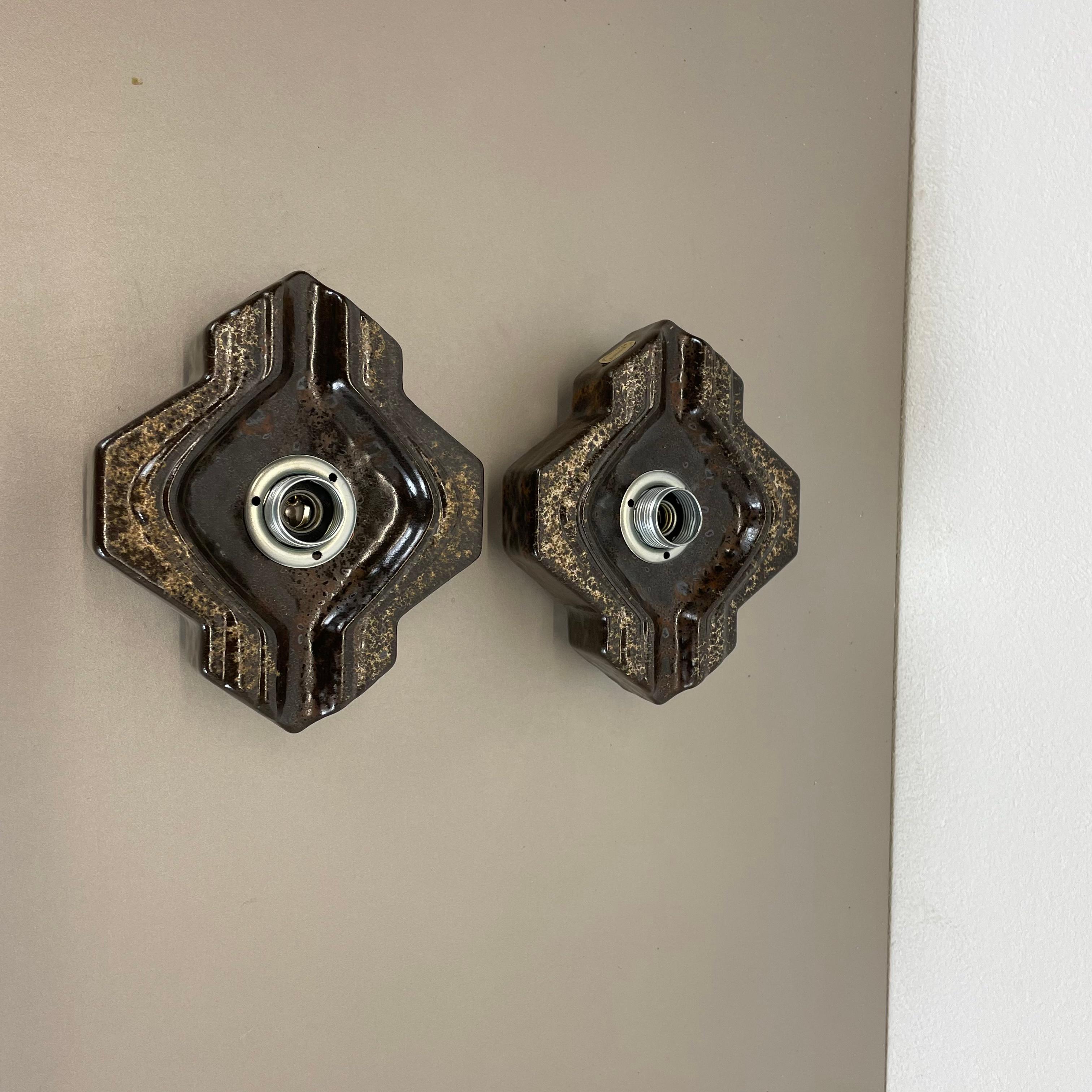 Article:

Wall light sconce set of two


Producer:

Pan Ceramic, Germany.



Origin:

Germany.



Age:

1970s.



Description:

Original 1970s modernist German wall light made of ceramic in fat lava optic. This super rare set of four walls light was