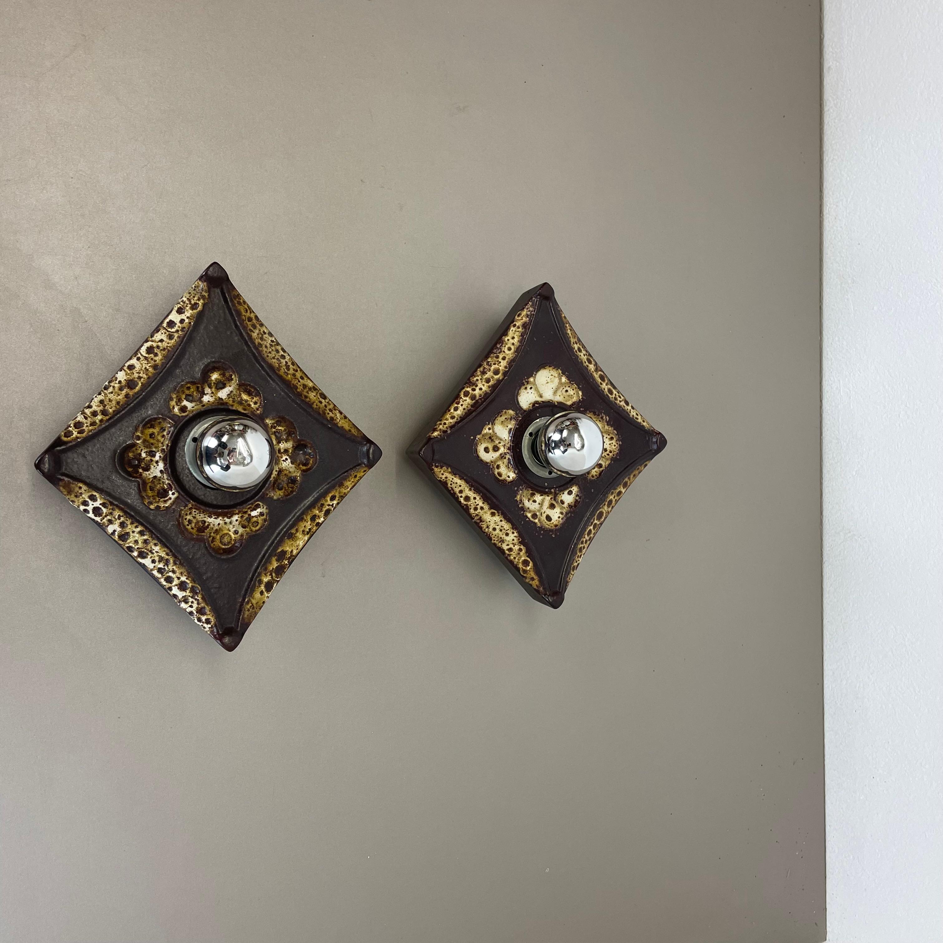 Article:

Wall light sconce set of two


Producer:

Pan Ceramic, Germany.



Origin:

Germany.



Age:

1970s.



Description:

Original 1970s modernist German wall light made of ceramic in fat lava optic. This super rare set of ftwo walls light was