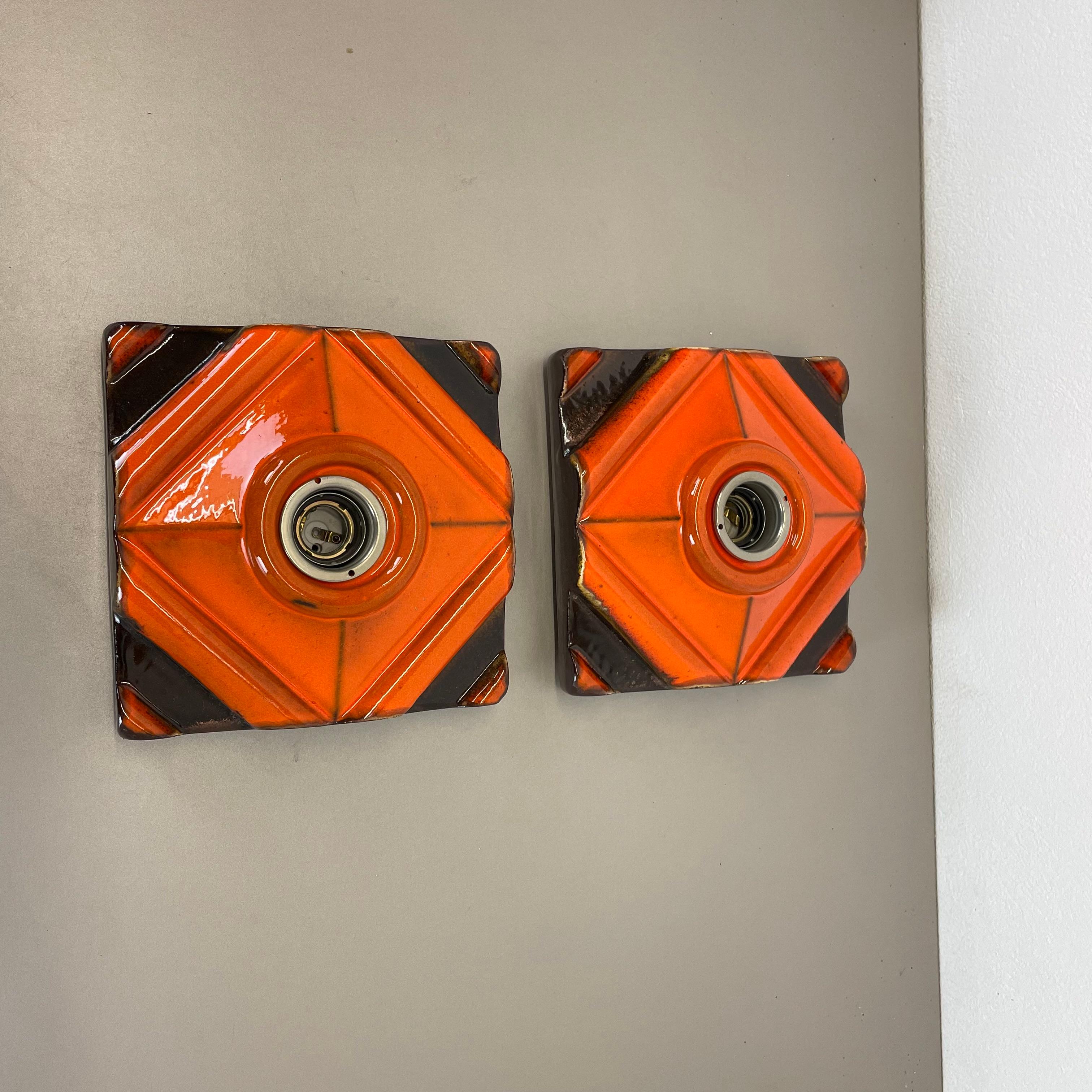Article:

Wall light sconce set of two.


Producer:

Pan Ceramic, Germany.



Origin:

Germany.



Age:

1970s.



Description:

Original 1970s modernist German wall light made of ceramic in fat lava optic. This super rare set of two walls light was