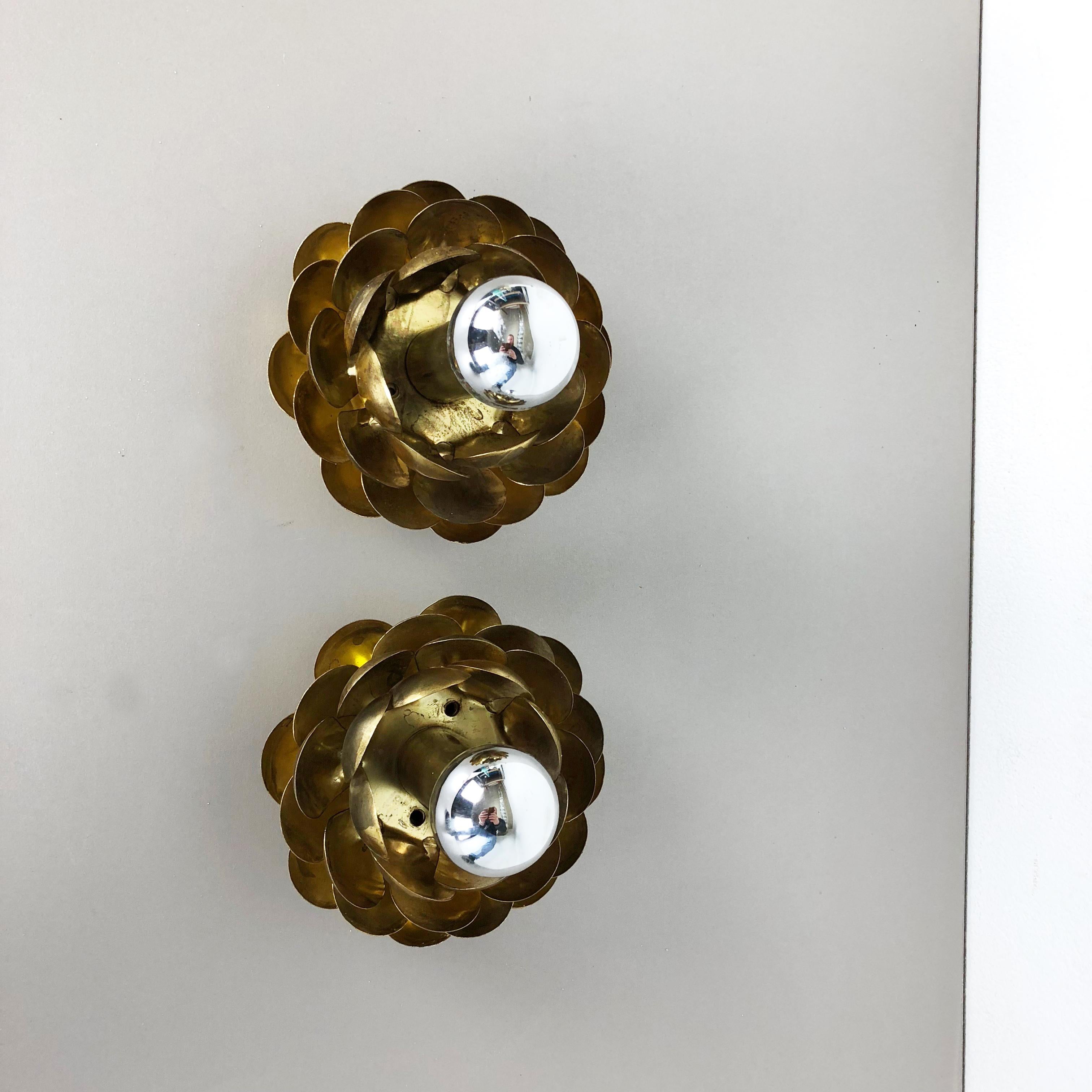 Article:

Set of two

Wall light ceiling light 


Origin:

Italy



Age:

1960s




This set of two modernist lights was produced in Italy in the 1960s. It is made from solid brass tone in floral form with little leaf elements