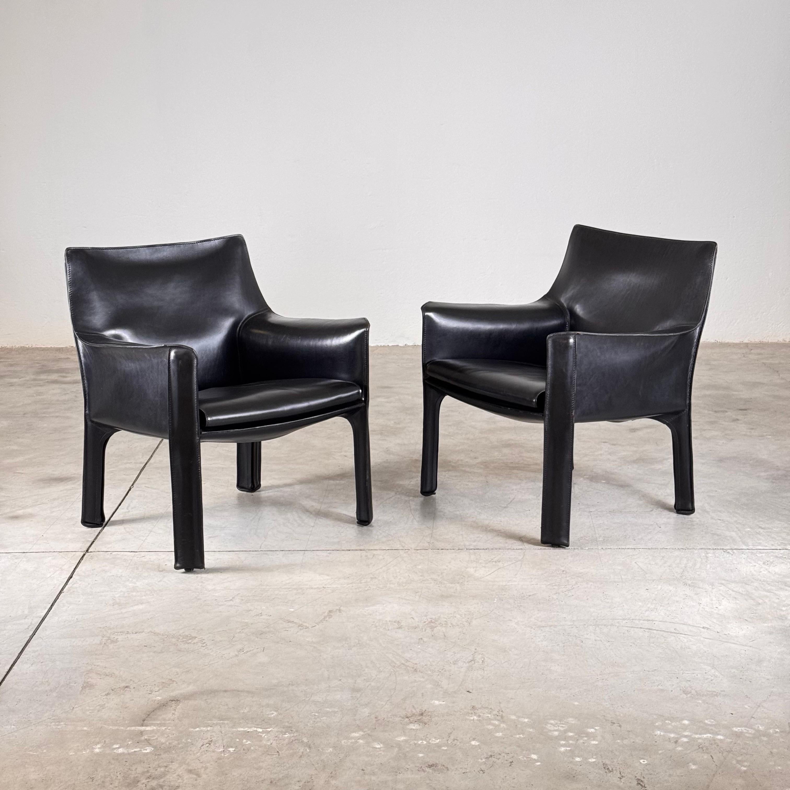 Exceptional set of Cab 414 lounge chairs in elegant black leather, designed by Mario Bellini in 1978 and produced by Cassina in the 1980s. These iconic chairs feature a tubular steel frame, layered with foam, and expertly encased in thick, supple