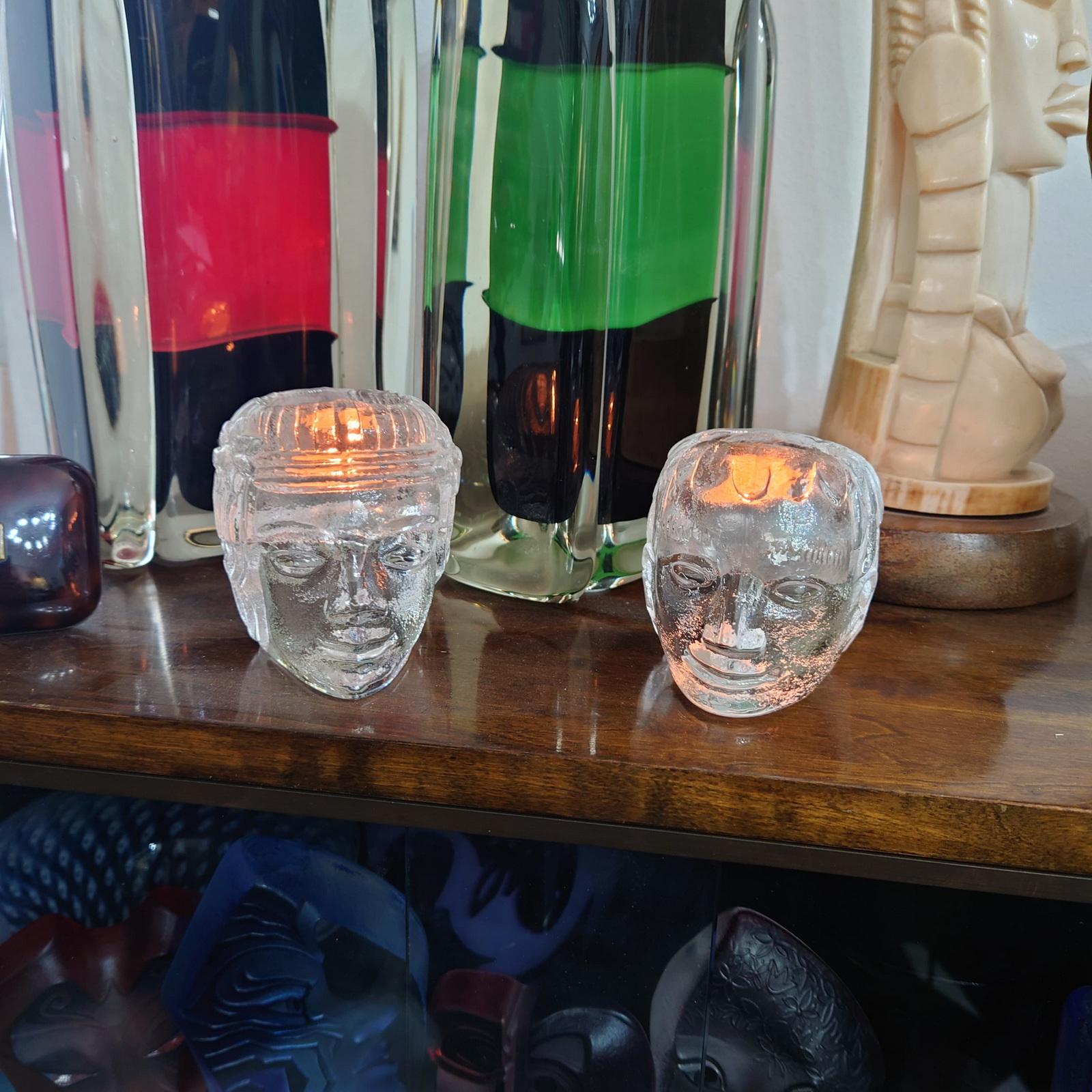 Set of Two Candle Holders Designed by Bertil Vallien for Kosta Boda in the 1960s.
Mid-century sculptural tealight votives, made of art glass and shaped like Greek heads, are in very good used condition.
Dimensions: 
Length: 9.5 cm
Width: 7.5