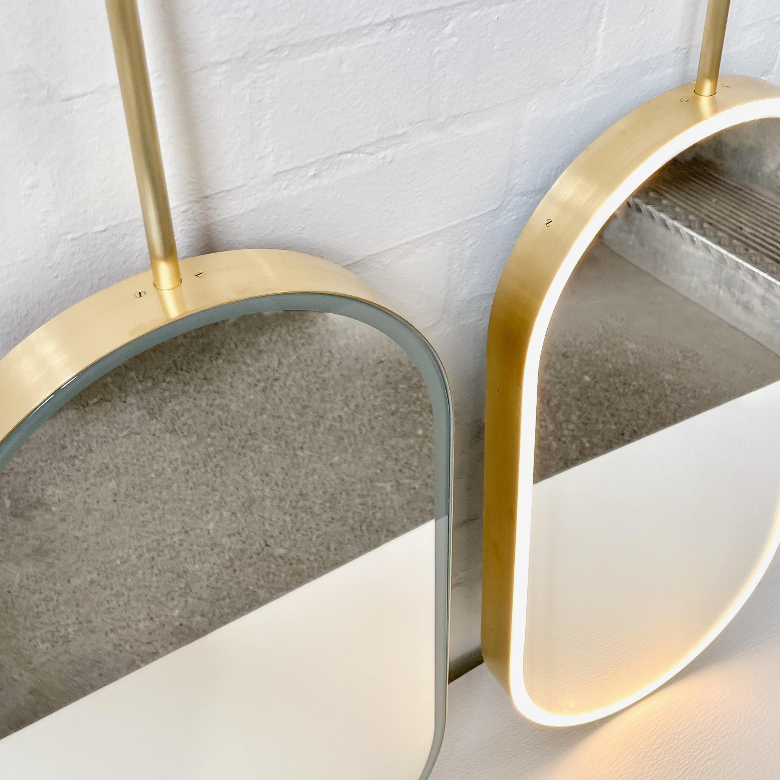 British Set of two Capsula Illuminated Modern Ceiling Suspended Mirror with Brass Frame For Sale