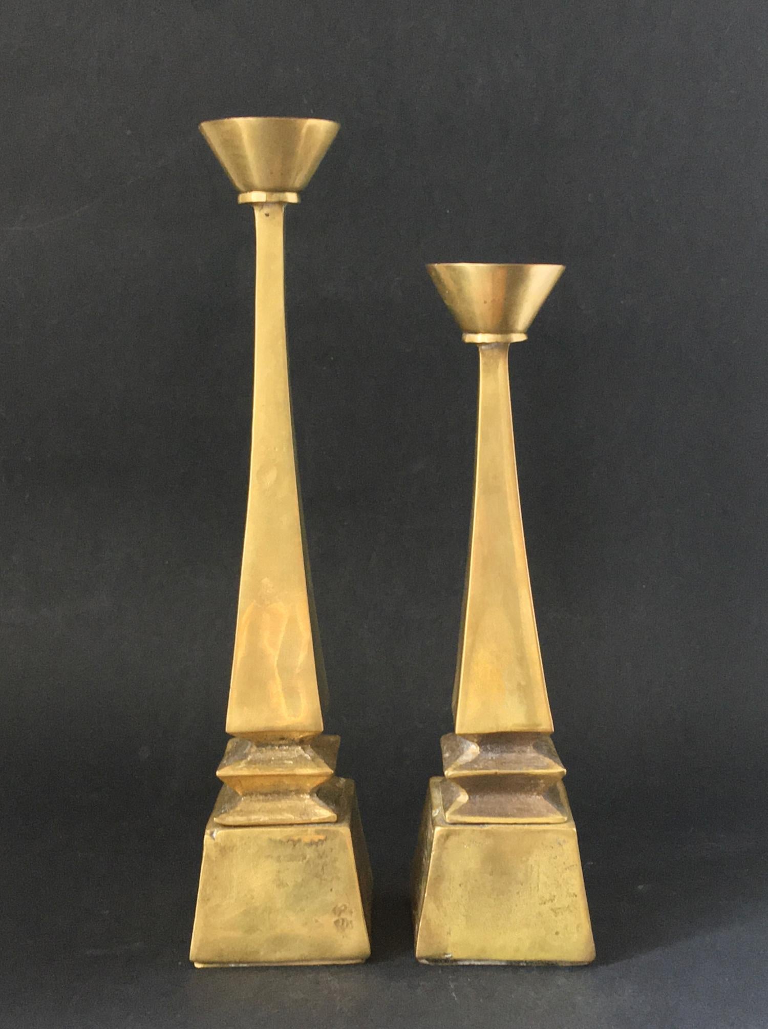 Set of two brass candleholders. Found in Germany, second half 20th century.

The cast brass components show nice combinations of smooth and rough textures, and visible asymmetry and imperfections from the casting process. There are small differences