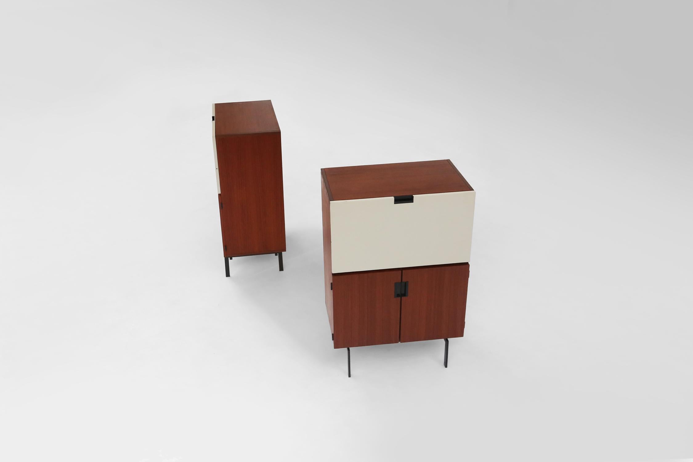 Set of two cabinets designed by the Dutch designer Cees Braakman in 1958 for Pastoe. This pair of the Japanese series is made of teak wood , a black metal base and a white door that can serve as a writing table.