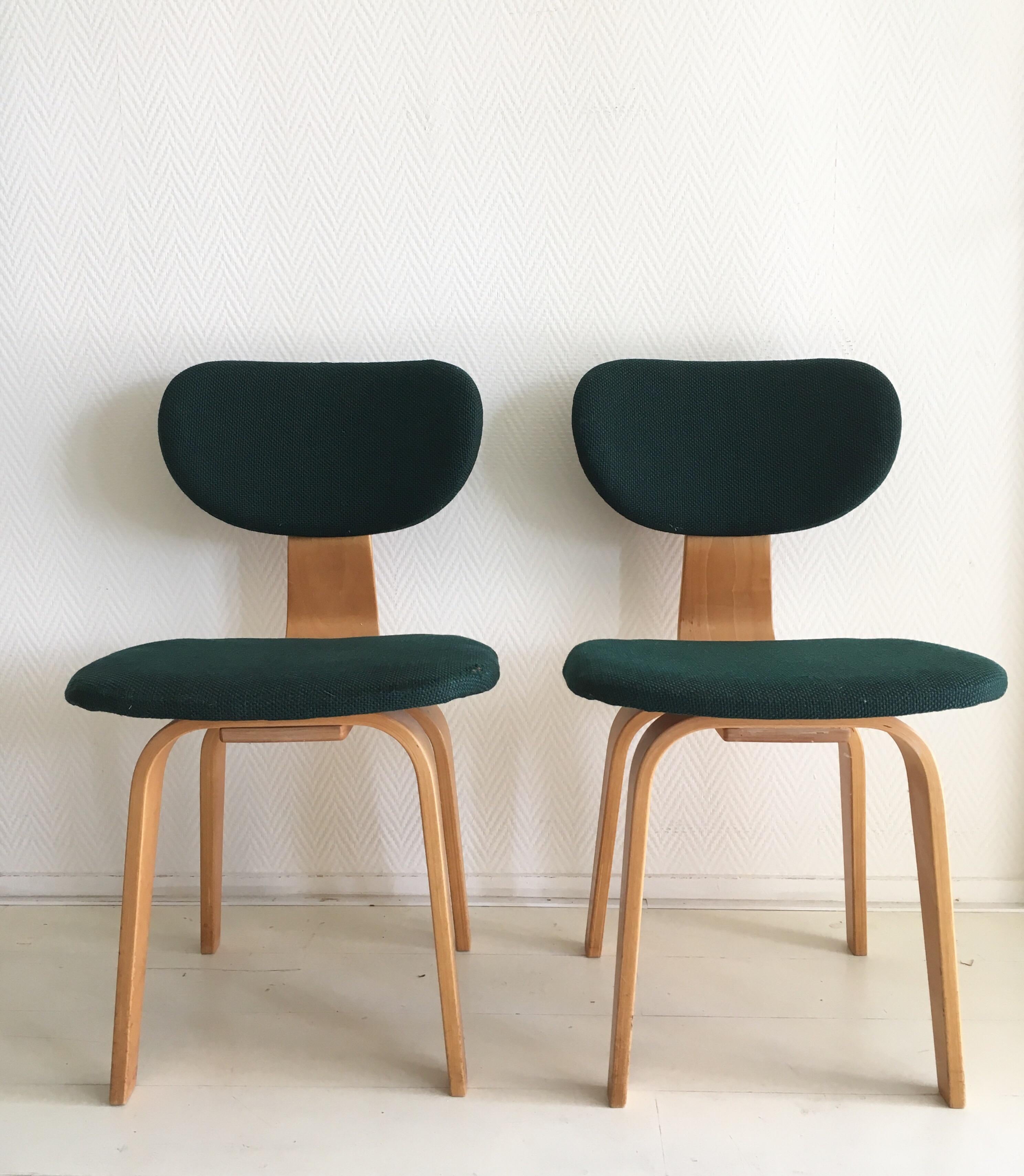 Stunning pair of birch and plywood chairs with green upholstery. They were designed by Cees Braakman for Pastoe in the 1950s (Combex Series). The chairs remain in very good condition, with some wear to the fabric and wear consistent with age and use.