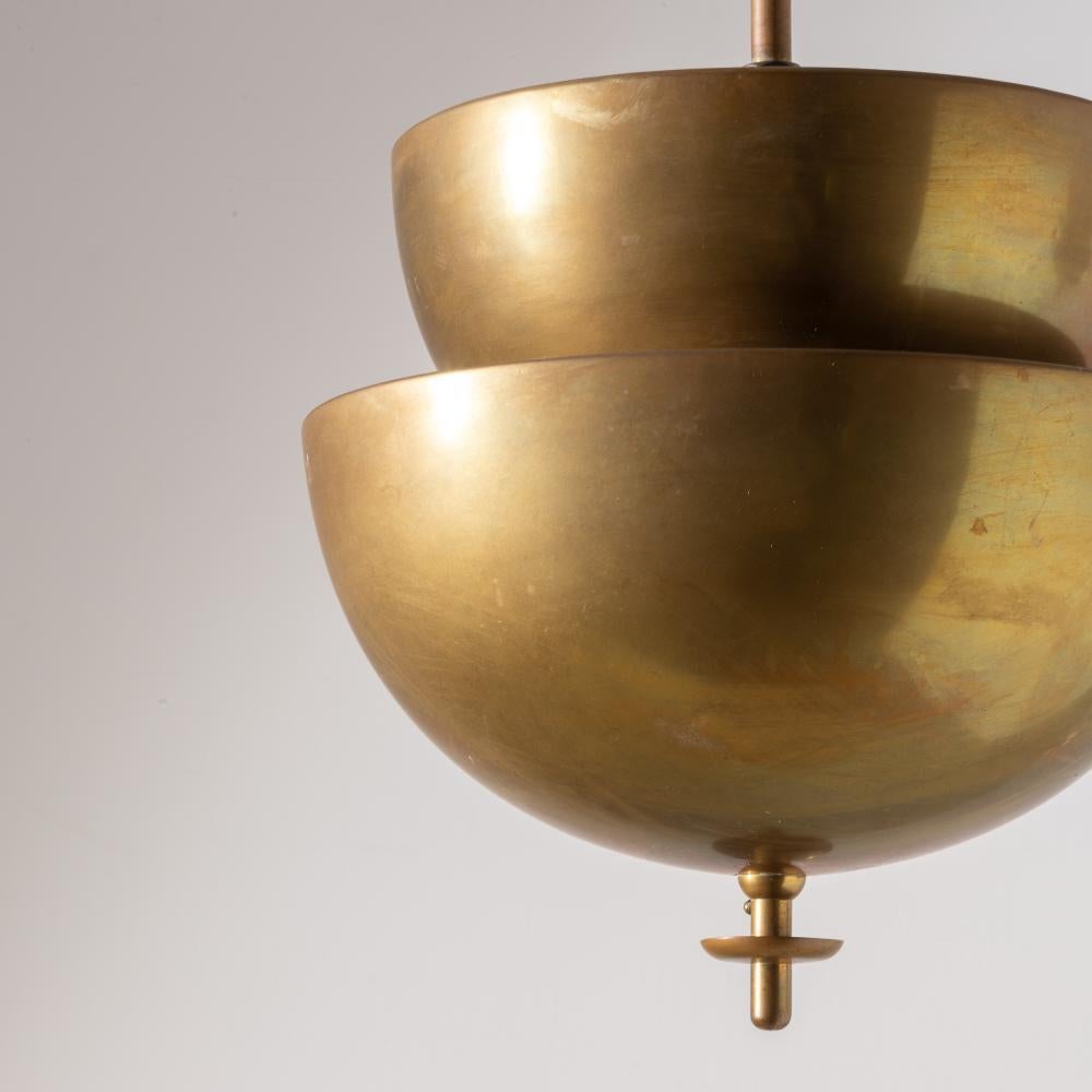 An exceptional and unusual set of two pendant lamps in brass and polished aluminium. Attributed to Marcello Piacentini. Luminator production. Italy from the 1930's.

One measures 30cm in diameter and 80 cm high, The other one is 25 cm in diameter