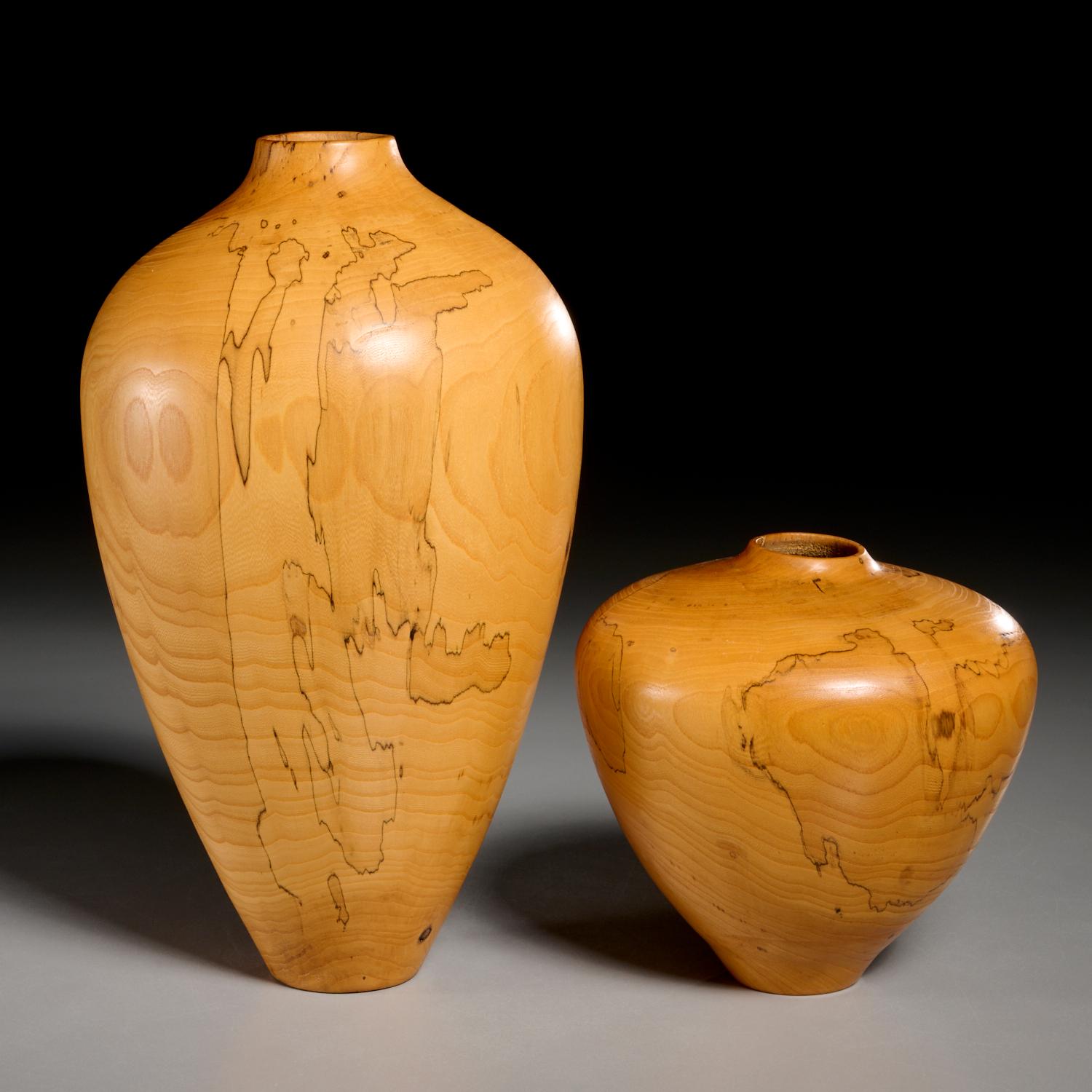 Charles Andre (American, b. mid‑20th c.) two spalted wood vases. Both are turned from elm, showcasing beautiful spalting details that trace through the forms, enhanced by a smooth, polished finish. In excellent condition with minor natural