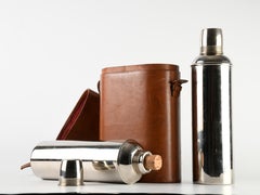 Set of two chrome-plated steel Thermos flasks, in a velvet-lined leather case