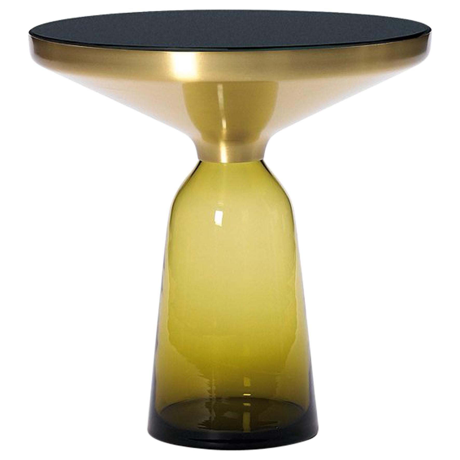 AVAILABLE WHILE STOCK LAST.
A modern classic as miniature: the bell table by Sebastian Herkner turns our perceptual habits on their head, using the lightweight, fragile material of glass as base for a metal top that seems to float above it. Hand