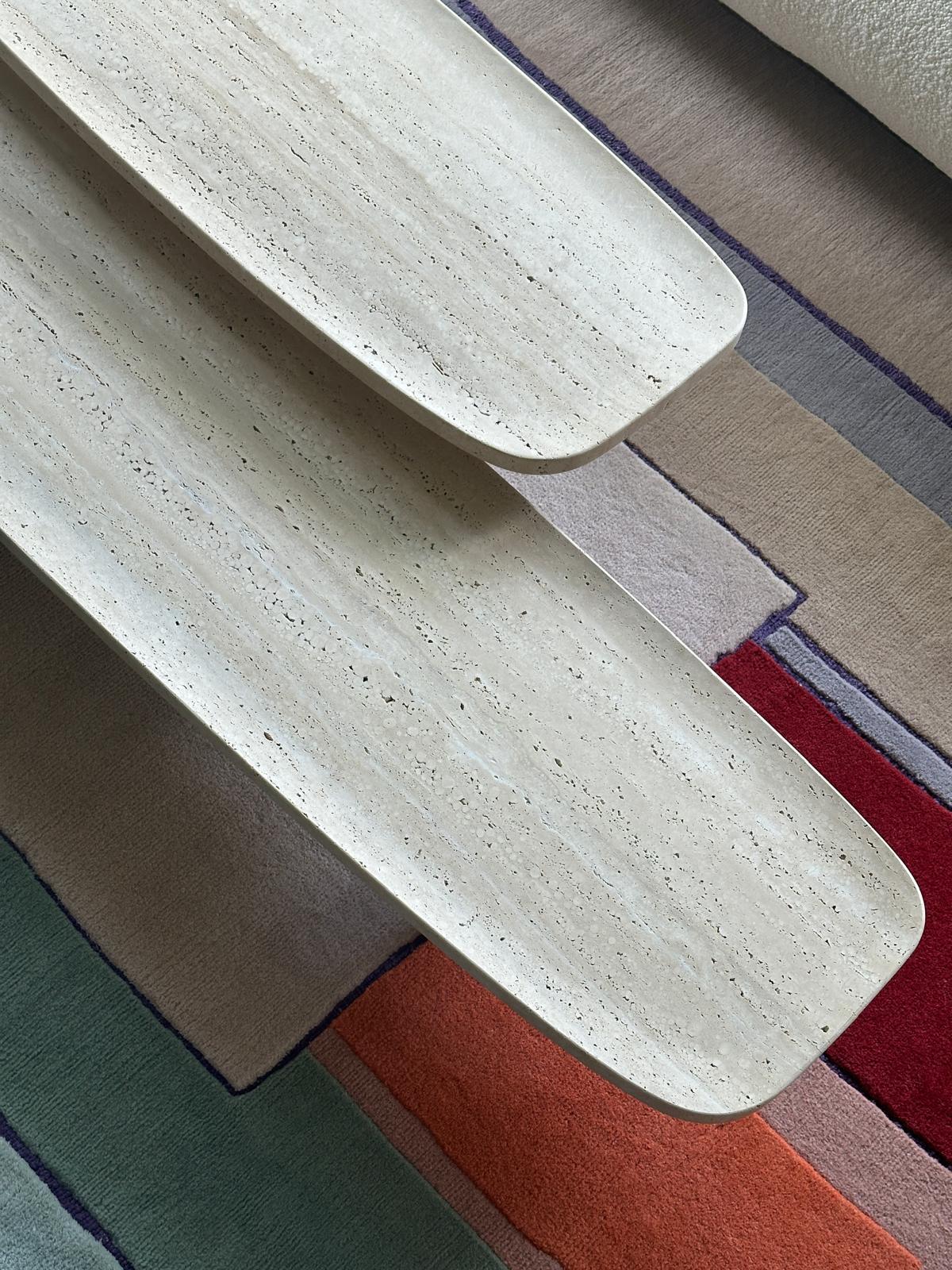Two different dimensions.
Travertine nature, Base maple.
One side table and one long table.

The Matéria Low Board series is characterised by its unusual dimensions and aura of tranquillity. When taking a closer look, however, its nearly