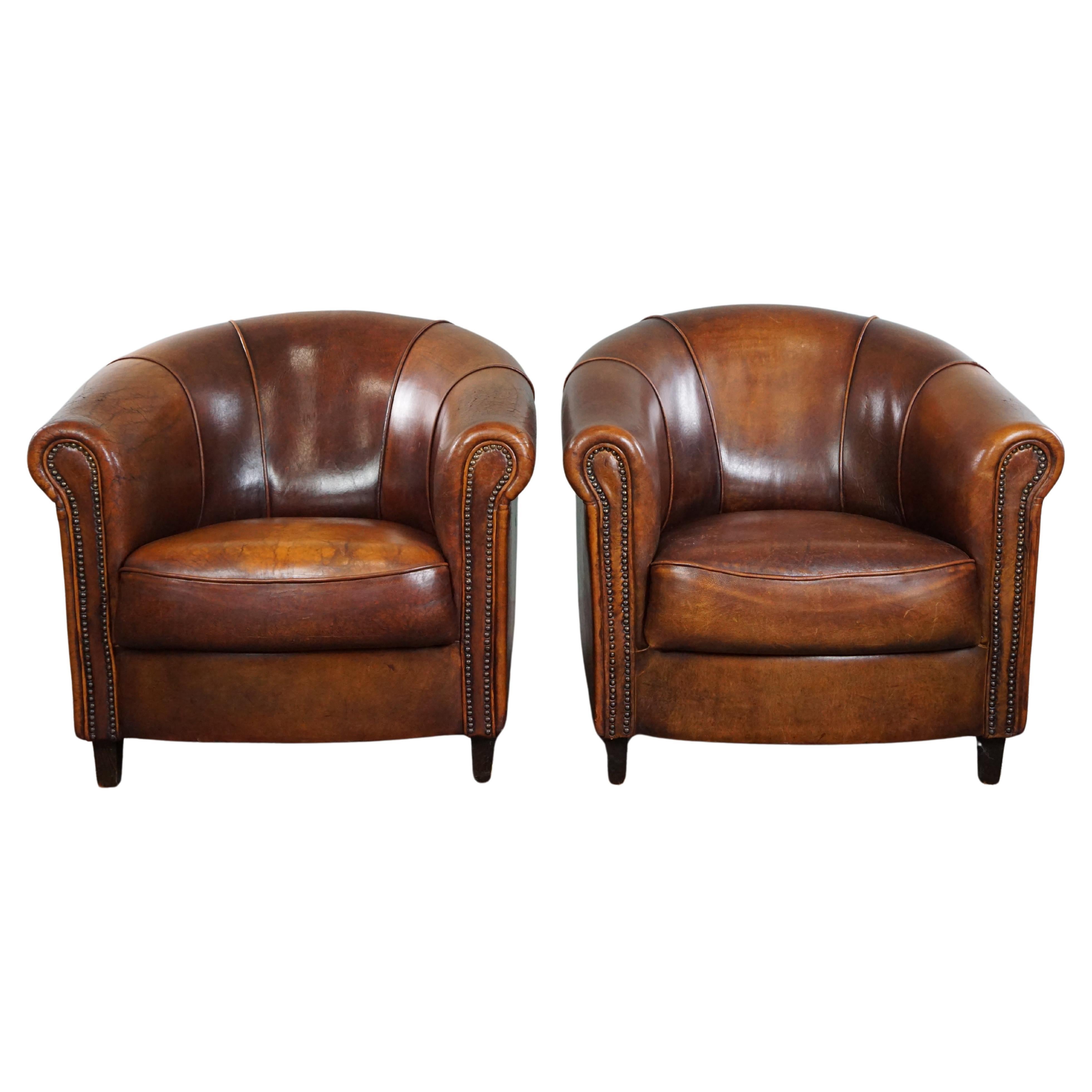 Set of two club armchairs made of sheep leather in a beautiful warm dark color For Sale