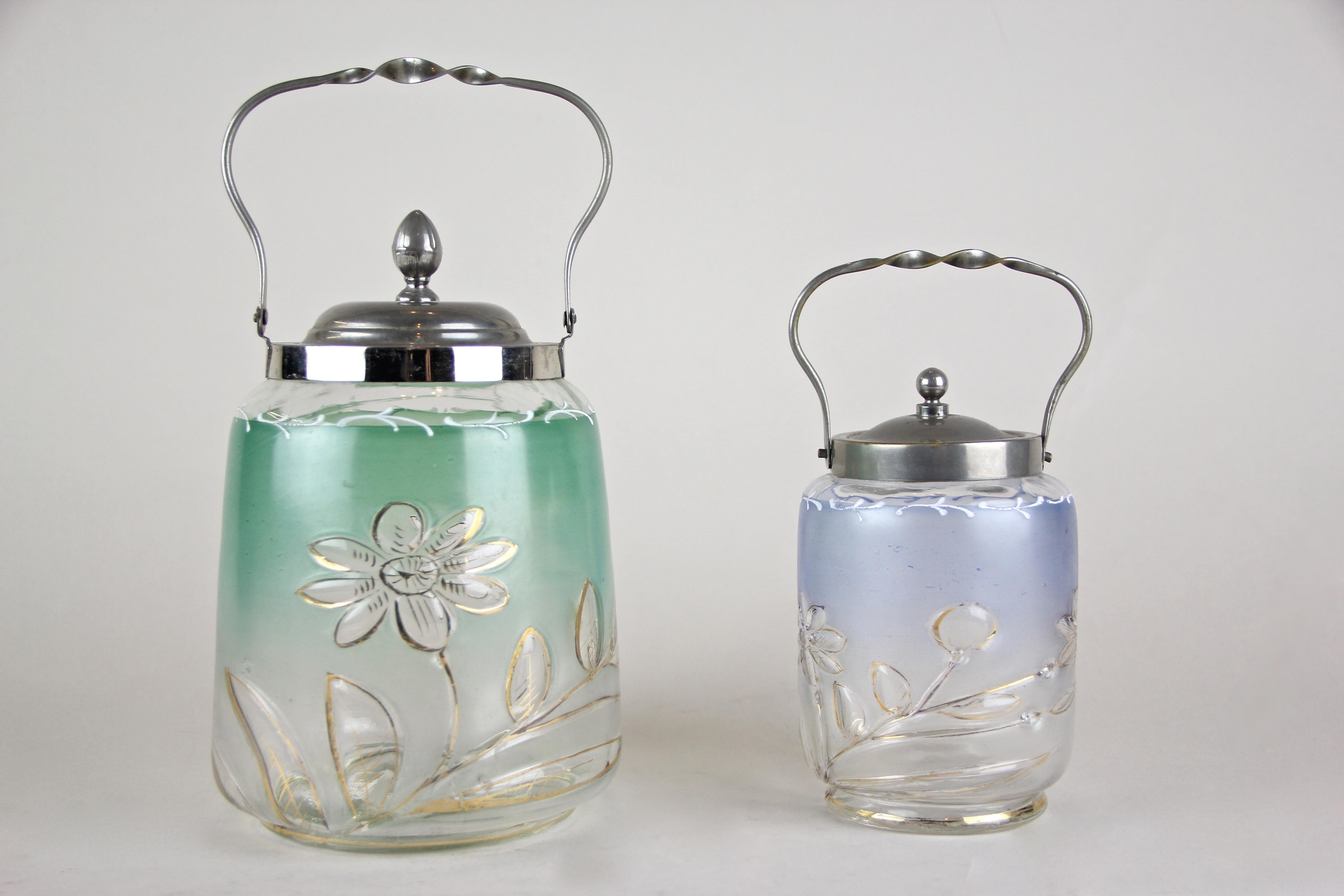 Lovely set of two colored glass jars or Bonbonniere with chromed lid from circa 1920 in Austria. Made of fine mouth blown glass, these two artfully painted jars show a beautiful coloration, the taller one in a light green - the smaller one in a
