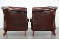 Set of two cow leather club armchairs in a luxurious red/brown colour