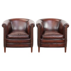 Set of two cow leather club armchairs in a luxurious red/brown colour