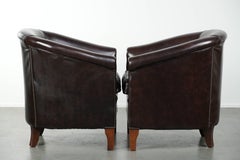 Set of two cowhide club armchairs in good condition with a English design