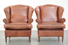 Set of two cowhide wingback chairs in English style with matching piping