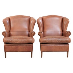 Set of two cowhide wingback chairs in English style with matching piping