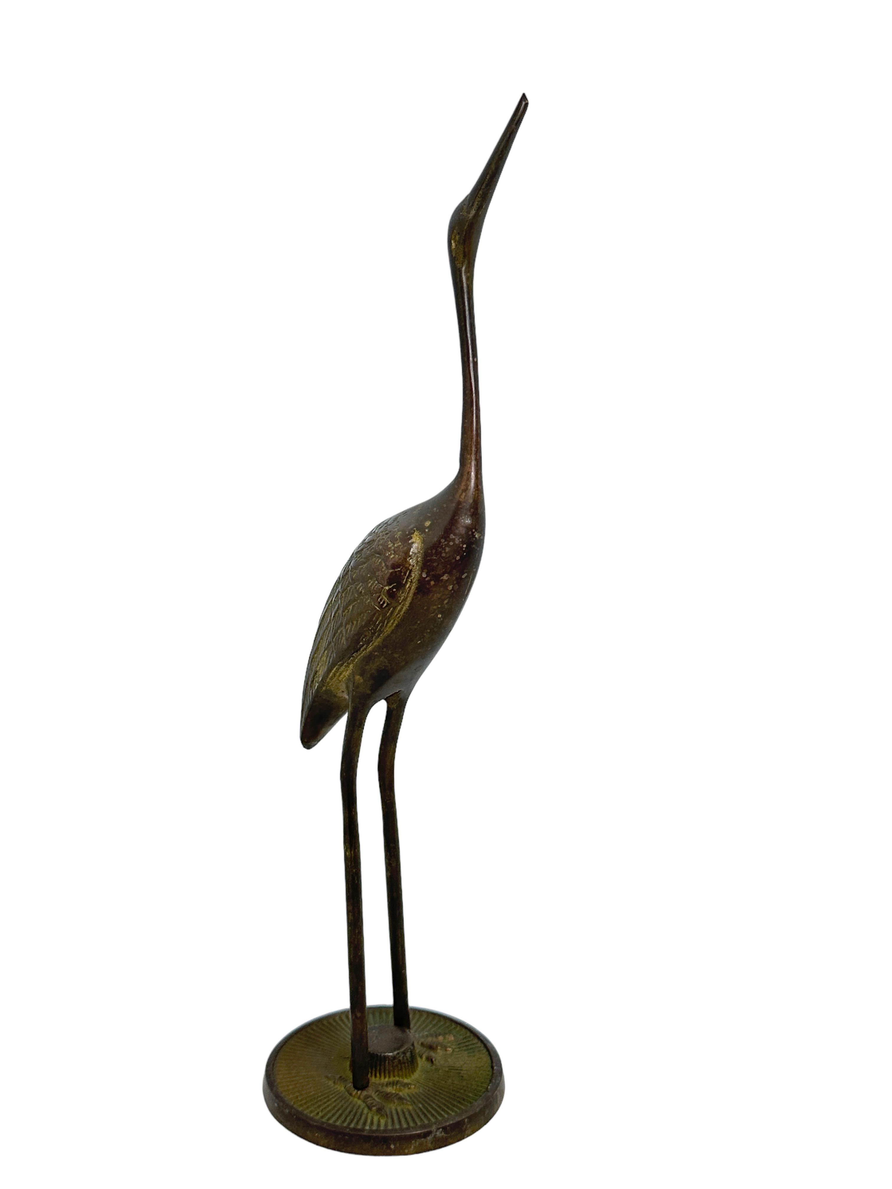 A set of two beautiful vintage brass crane or heron statues. This decorative item would make a beautiful addition to any room. Made in the 1960s it displays the joy of that great era with a bold, yet classy statement. They have a beautiful patina.