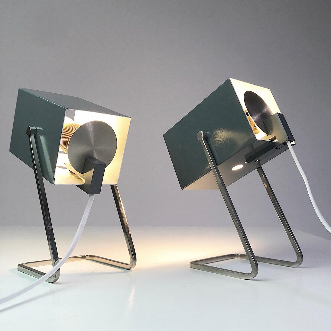 Beautiful set of well built table lamps by Kaiser Leuchten, Germany, 1960s.

Cube is the nickname of this minimalistic set of lamps. The cube shaped shade can be tilted up and down but not sideways.

Chrome base holders combined with grey and white