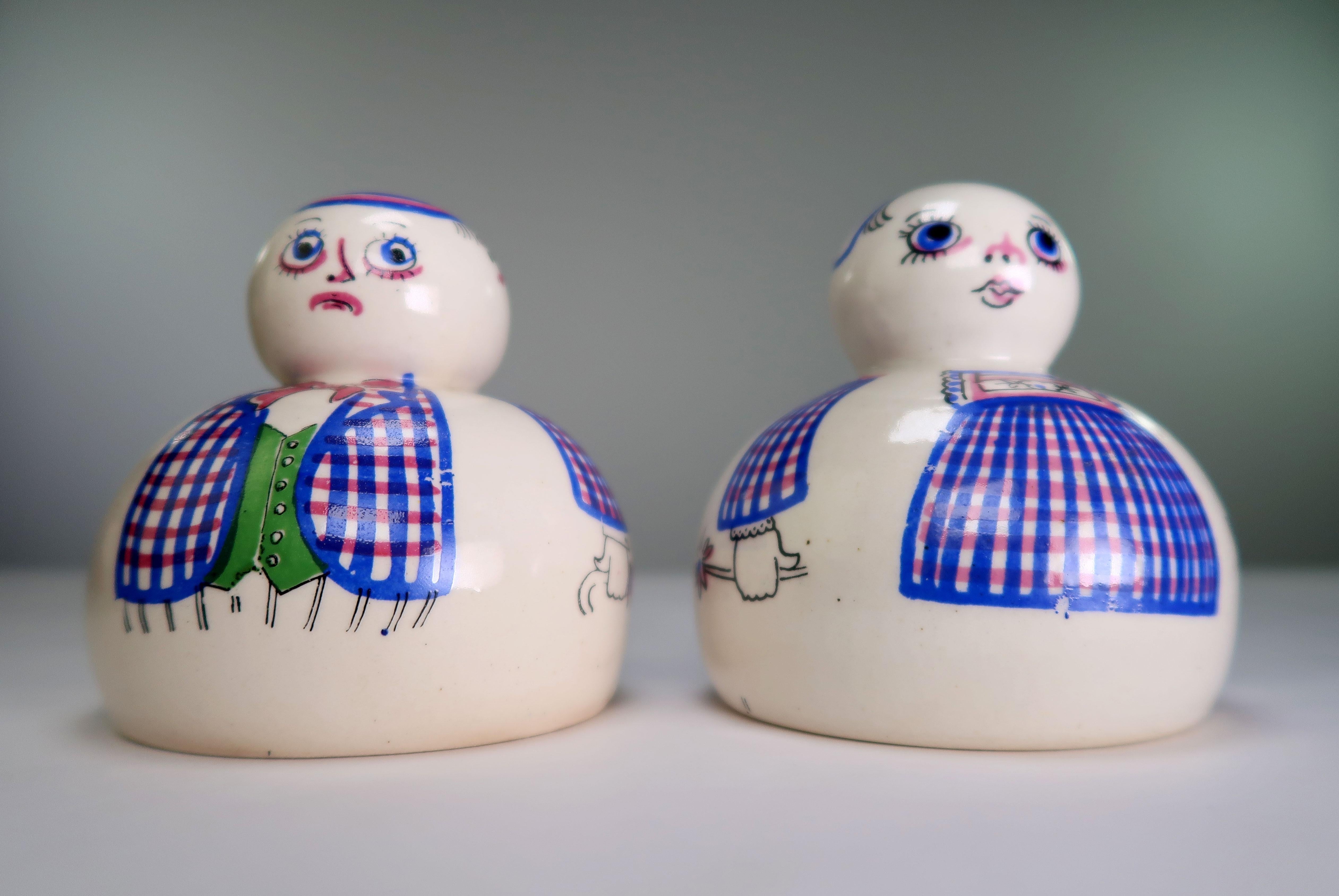 Set of two decorative Danish Mid-Century Modern handmade and hand-painted stoneware pepper shakers by Aksini. Designed and manufactured in the mid 1950s by Danish ceramic artist and painter Aksel Sigvald Nielsen (1919-1989), hence the production