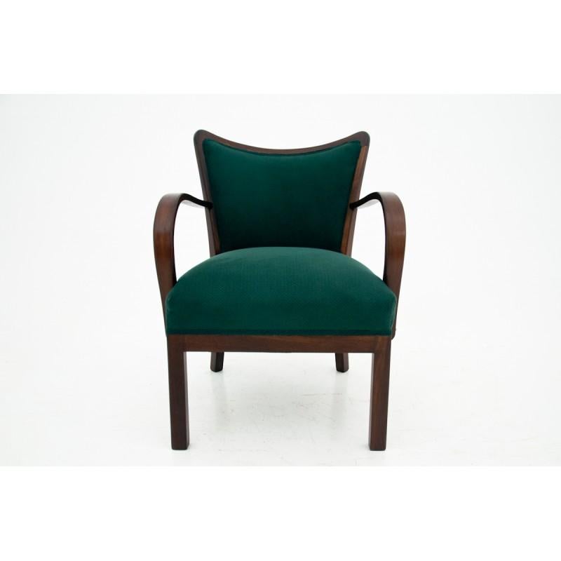 A pair of club armchairs with bent armrests was produced in Poland in the 1950s. The armchairs were renovated and the upholstery was replaced with a new one, dark green. The condition is very good. Comfortable and stabile.

    