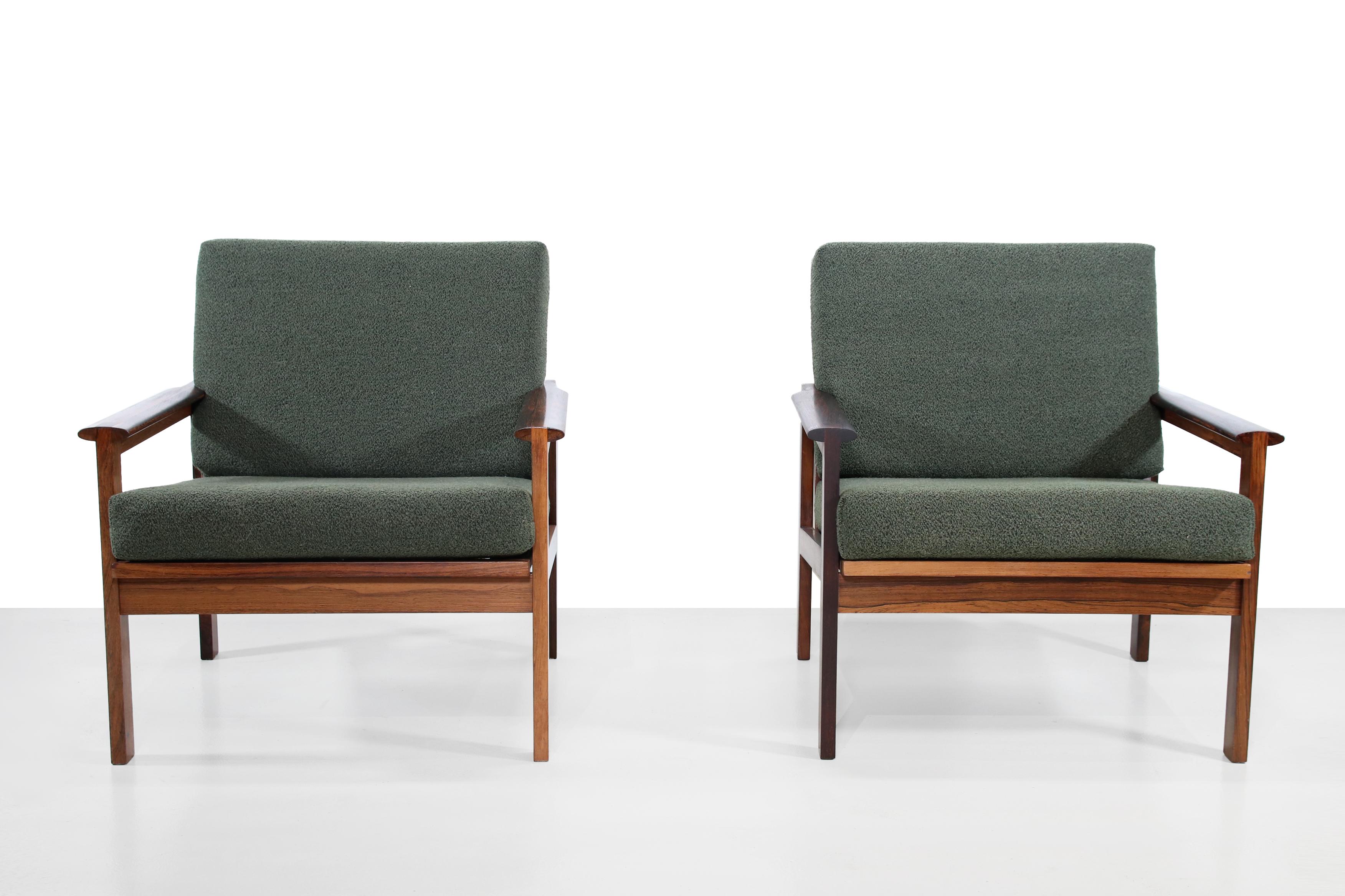 A pair of solid teak armchairs designed by Illum Wikkelsø, and produced by Niels Eilersen in Denmark. These armchairs with model name no 4 Capella come from the late 1950s. The armrests in particular show the beautiful craftsmanship of these