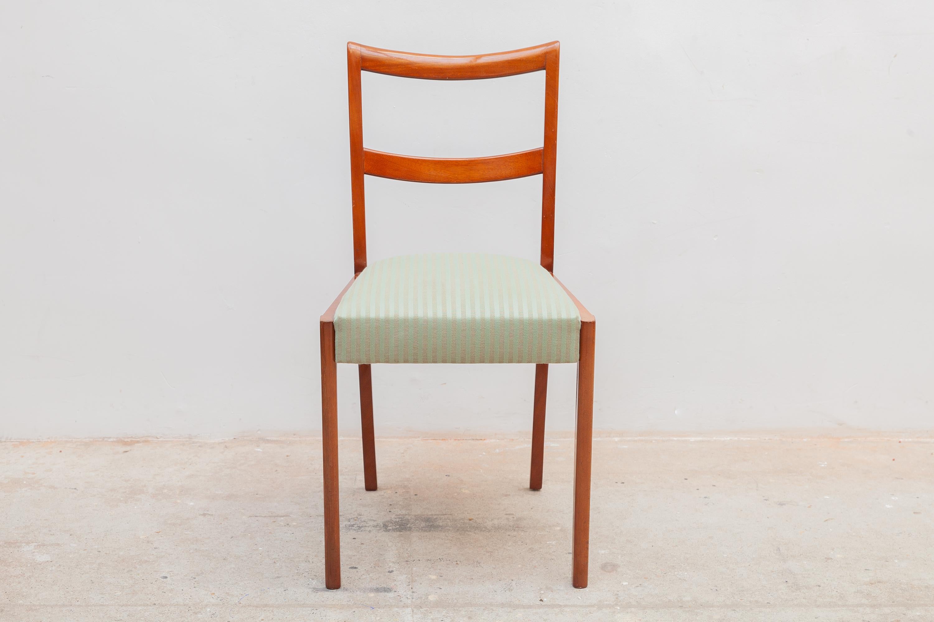 A pair of antique ladder back wooden side chairs. Green stripe upholstery. Dimensions: 45W x 82H x 43D cm Seat: 47cm high