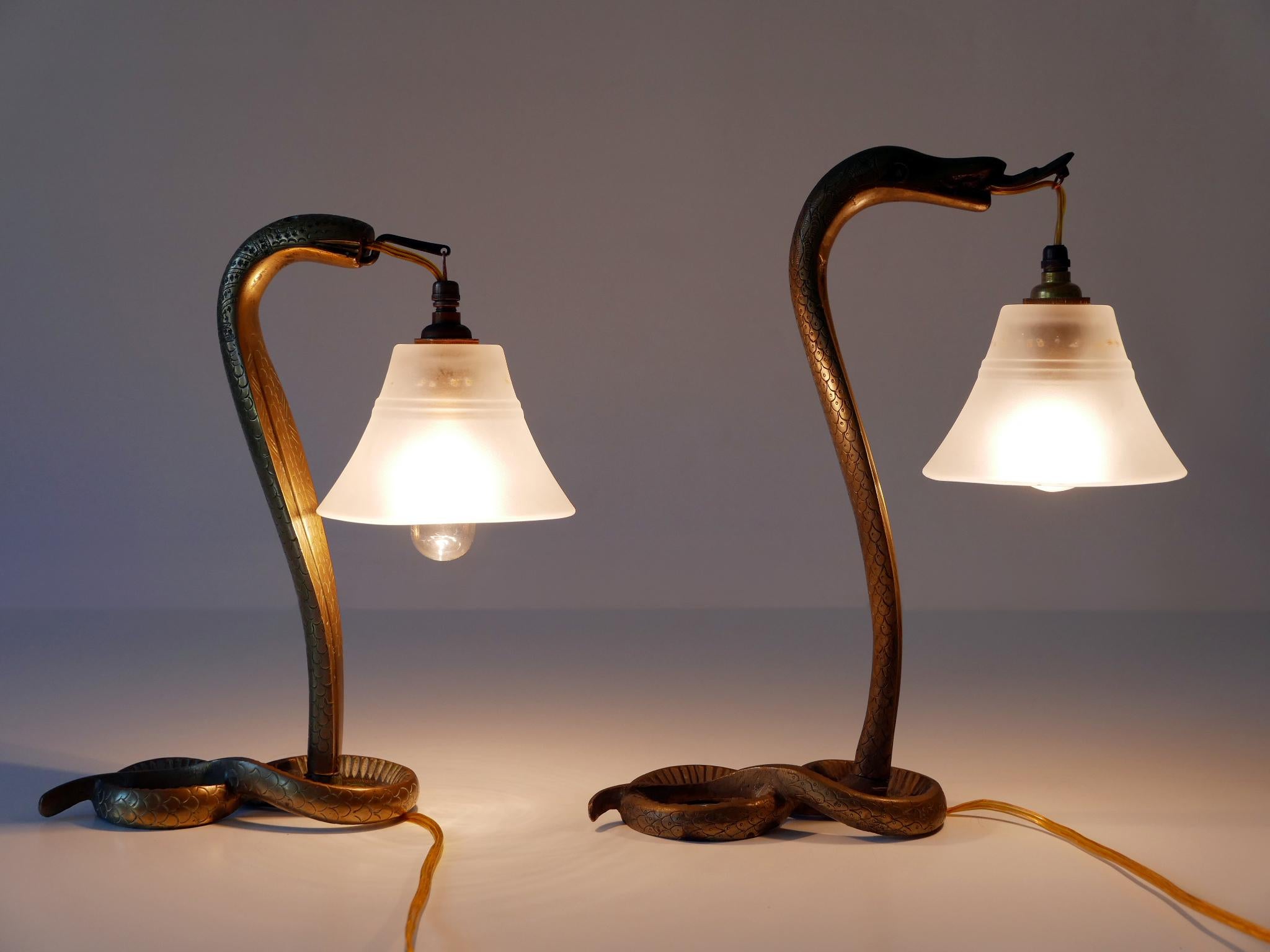 Set of two rare and highly decorative Art Nouveau bronze cobra table lamps. With oriental ornaments. These lamps were probably manufactured in Syria (a French Protectorate after World War I) around 1910s/1920s and exported to France. The previous