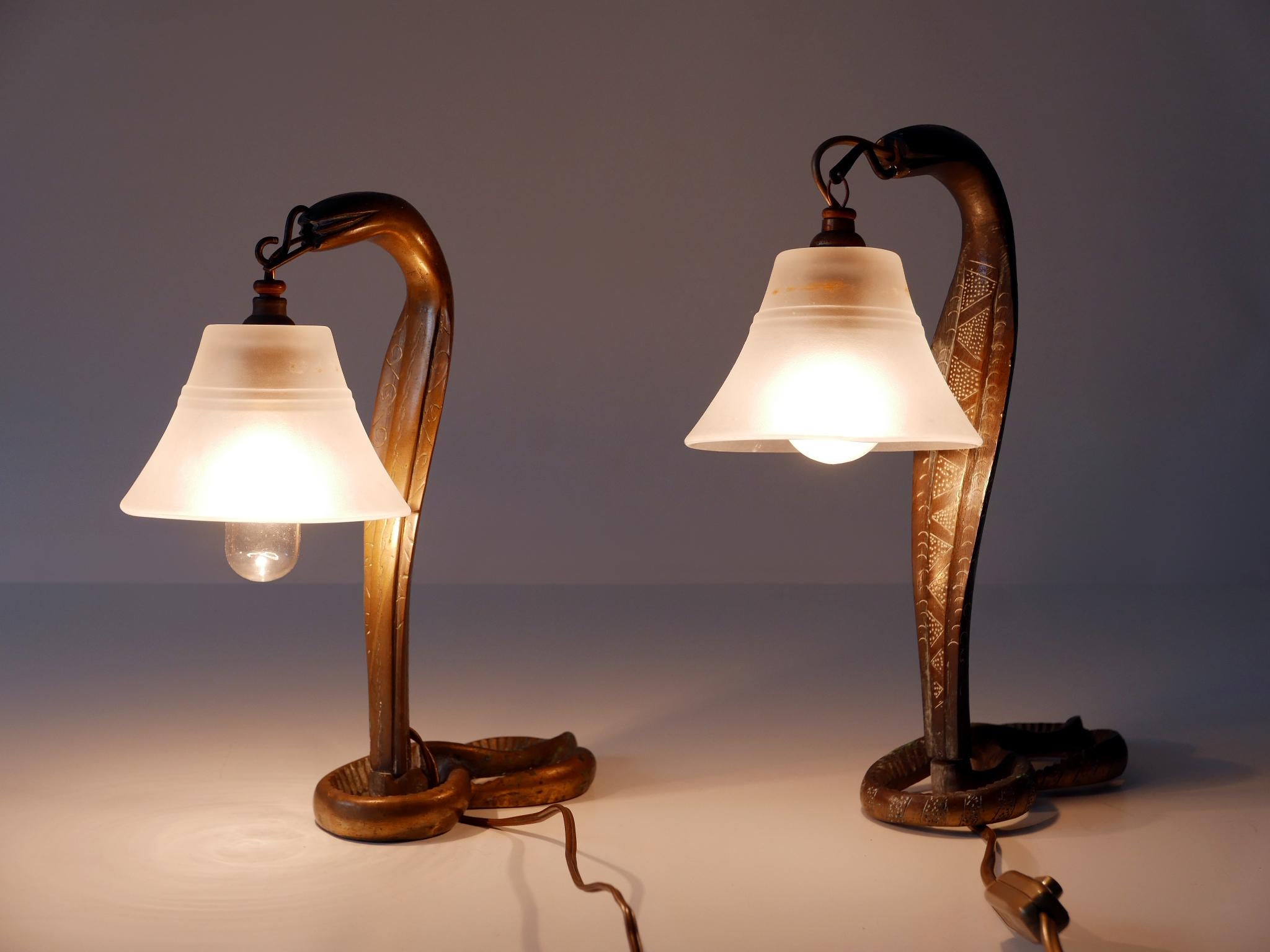 Set of two rare and highly decorative Art Nouveau bronze cobra table lamps. With oriental ornaments. These lamps were probably manufactured in Syria (a French Protectorate after World War I) around 1910s/1920s and exported to France. The previous