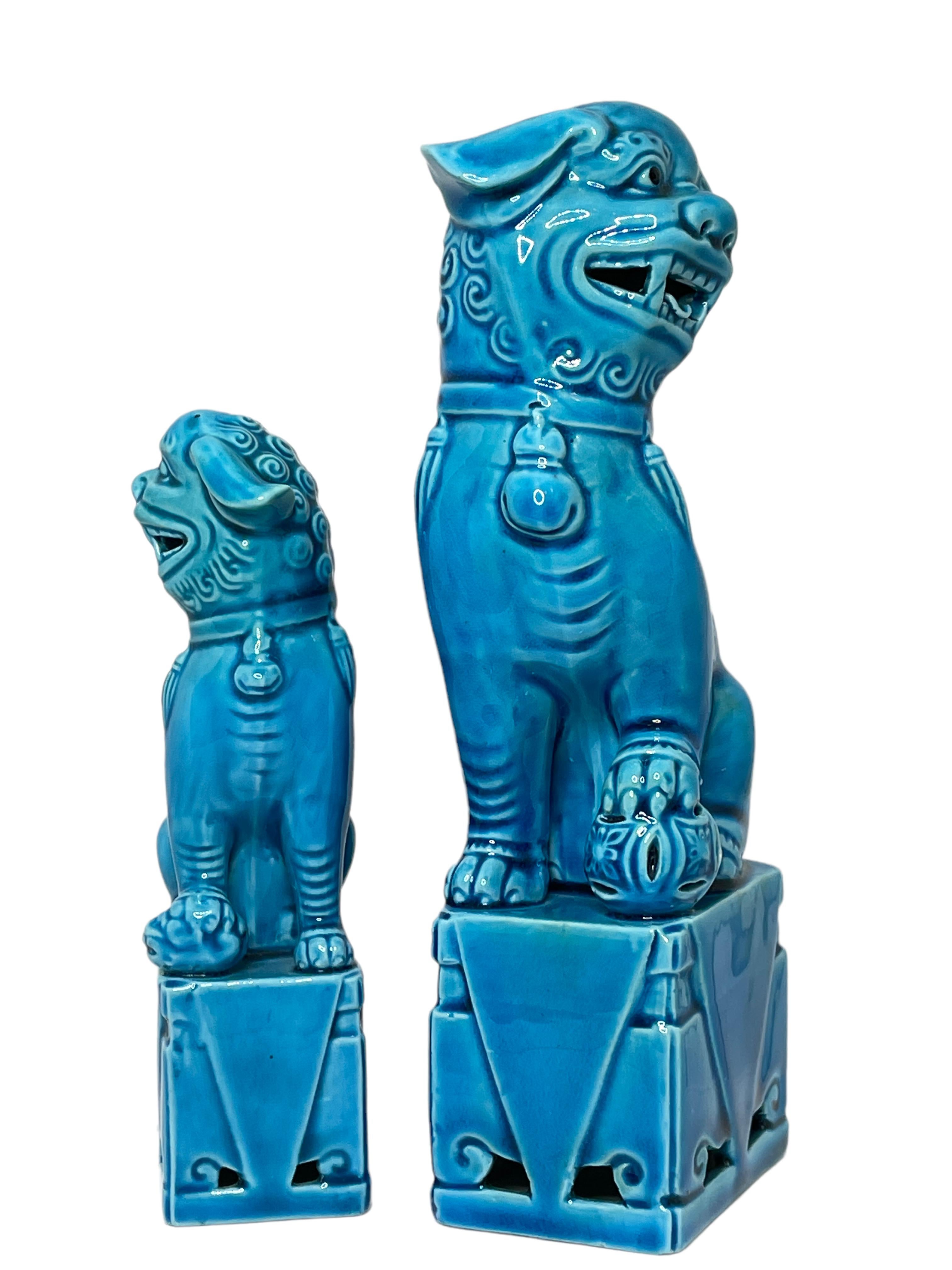 A very nice pair of vintage, turquoise blue, ceramic foo dogs, circa 1980s. Excellent condition and patina; makes a fun decor item in any room! Size given in measurements section refers to the largest item. The smaller one is approx. 4 5/8