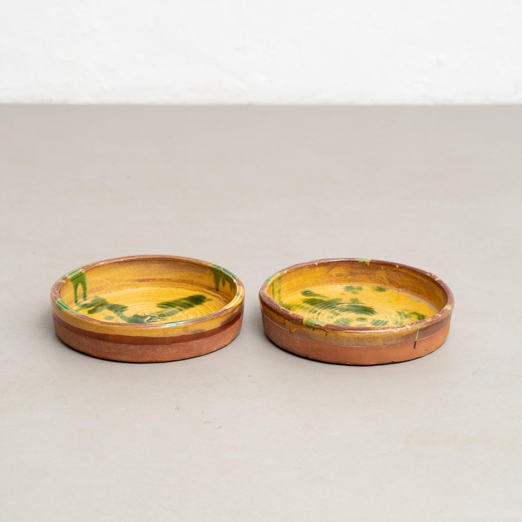 Set of two Early 20th century hand painted rustic popular traditional ceramic.
By unknown artisan, France.
In original condition, with minor wear consistent with age and use, preserving a beautiful patina.

Materials:
Ceramic

