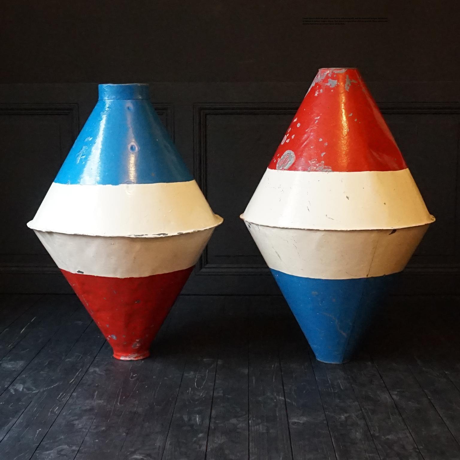 Set of two very decorative handmade and hand painted antique large early 1920s Dutch marine metal buoys.
They are diamond or biconical shaped, and painted in the colours of the Dutch flag, red white and blue. 
Hollow inside, to place over a rope or