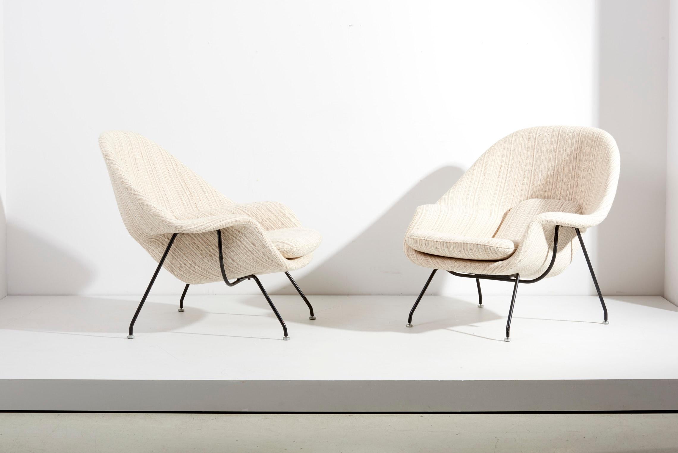 Set of two Early Eero Saarinen womb chairs and ottoman for Knoll, USA - 1960s. Newly upholstered in a Knoll fabric. The measurements given apply to the chair. The ottoman measures 55cm in depth, 70cm in width and 40cm in height. 
Upholstered in