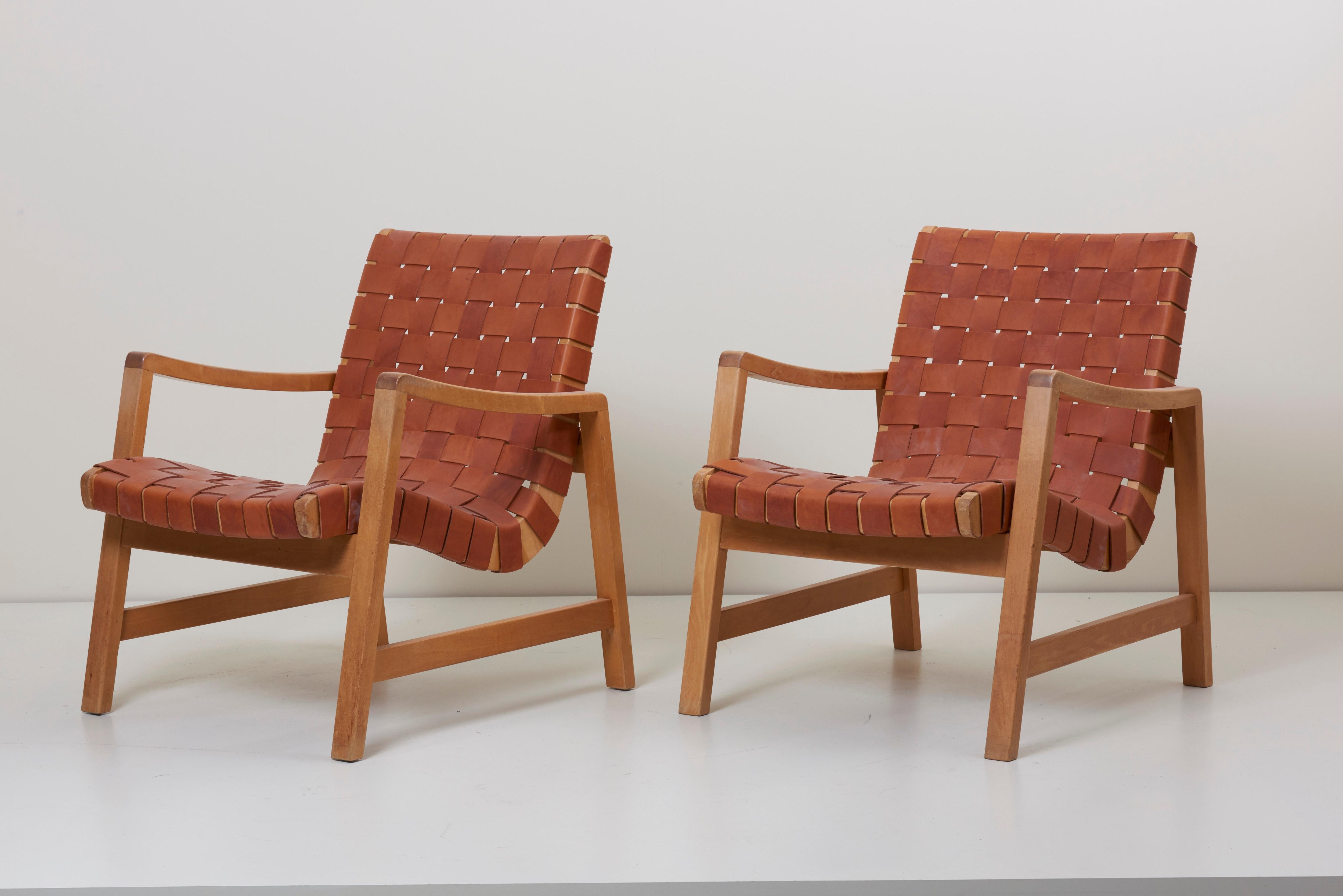 Set of two early Jens Risom armchairs by Knoll (labeled) with new high quality leather webbing. Excellent vintage condition.